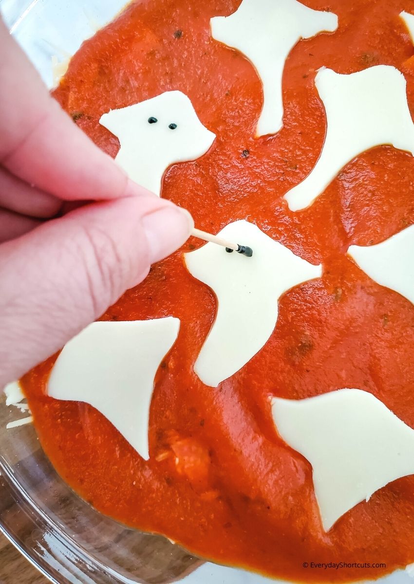 Make Eyes with Black Icing on Cheese Ghosts