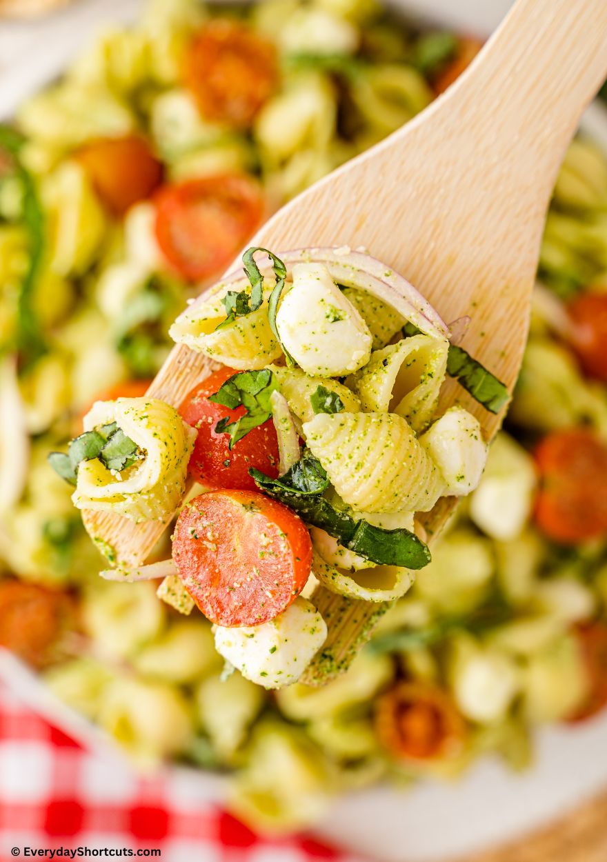 pesto pasta salad on a serving spoon
