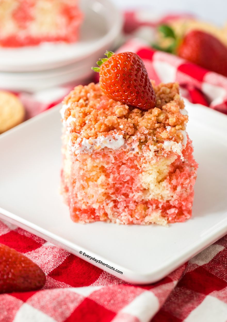 Strawberry crunch poke cake on a plate