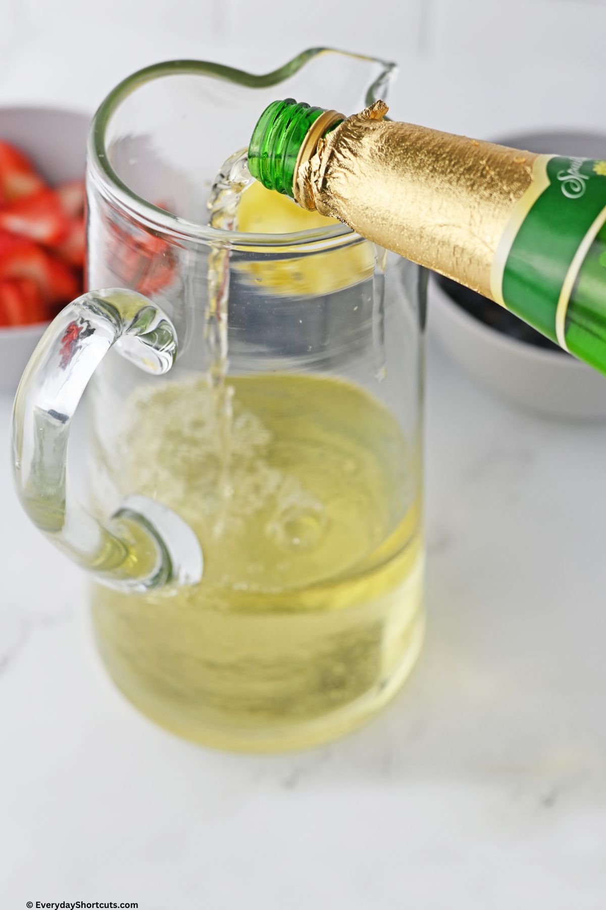 pour white grape juice in a pitcher