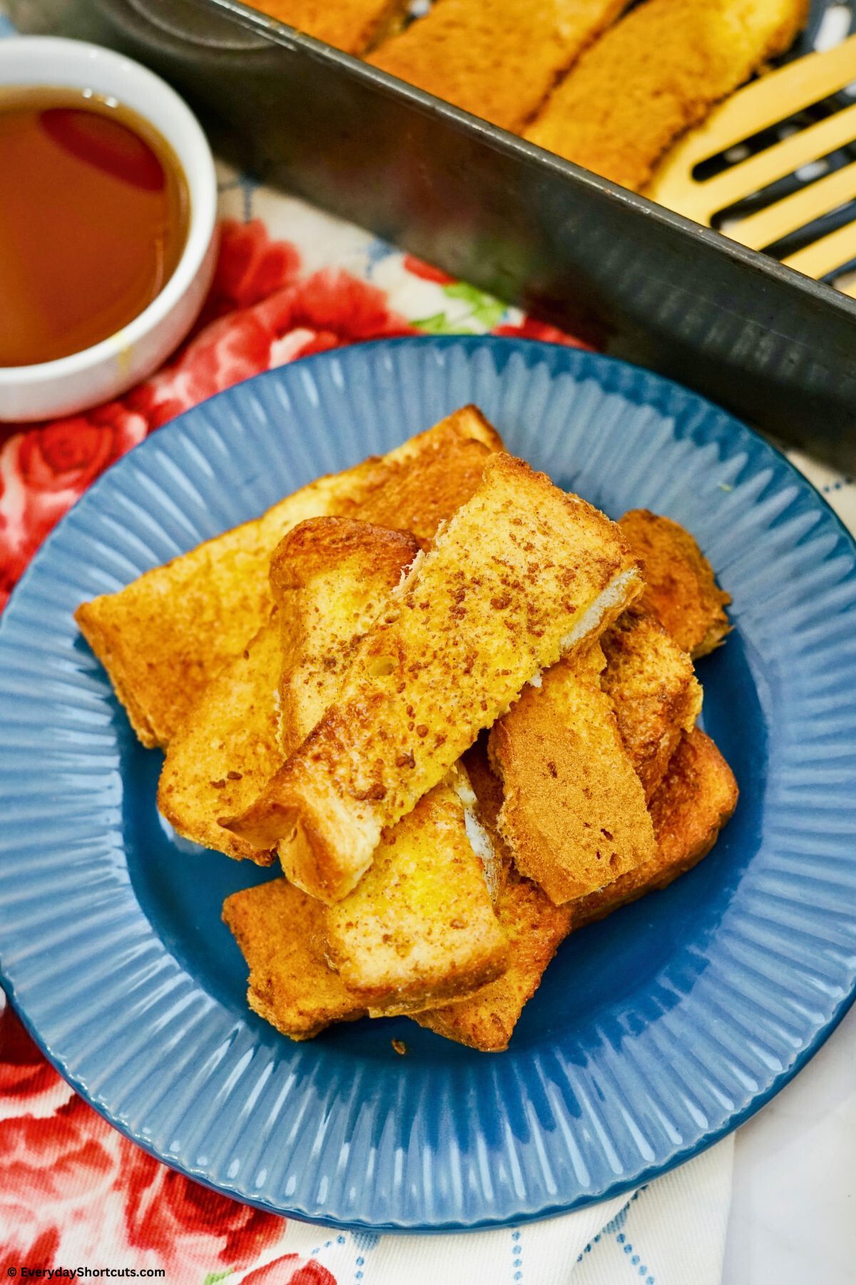french toast sticks on a plate with syrup on the side