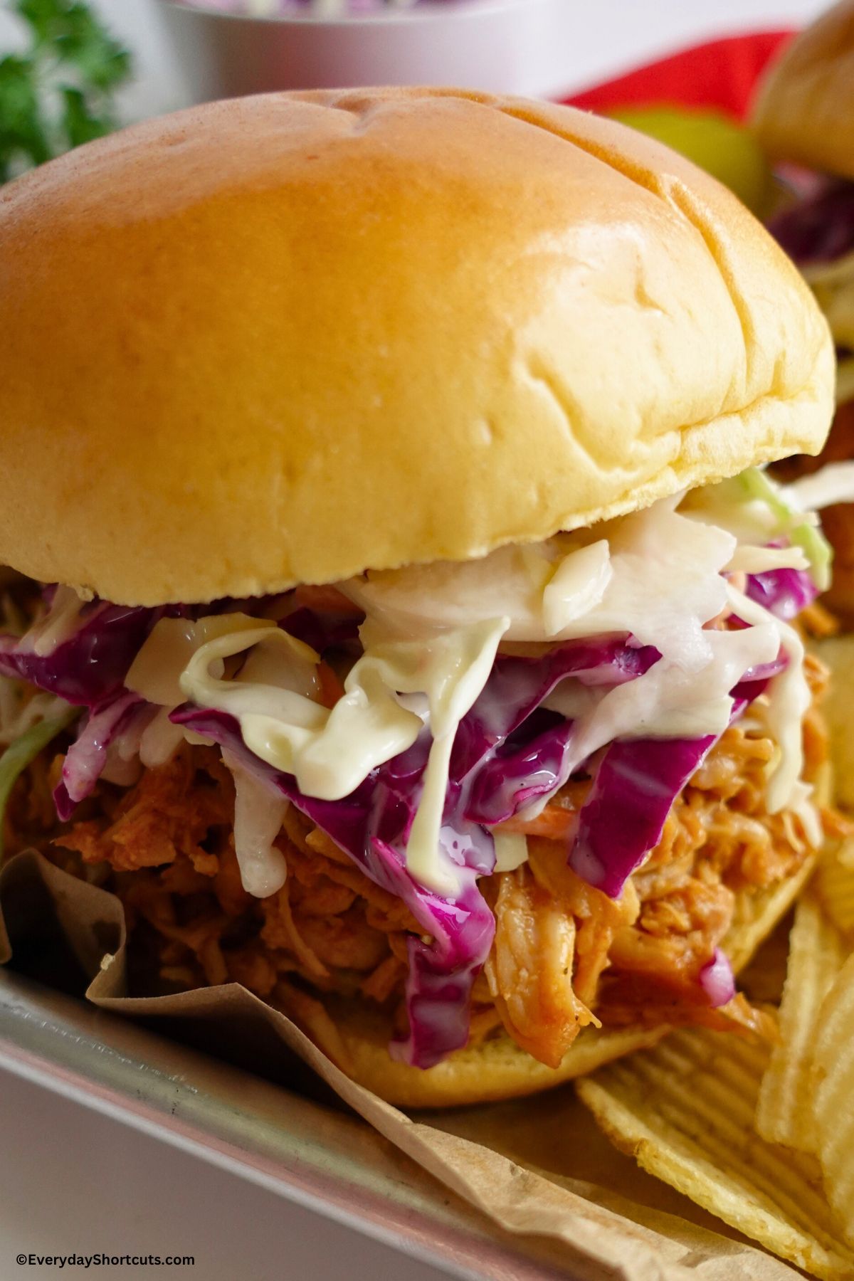 BBQ pulled chicken on a sandwich bun with coleslaw