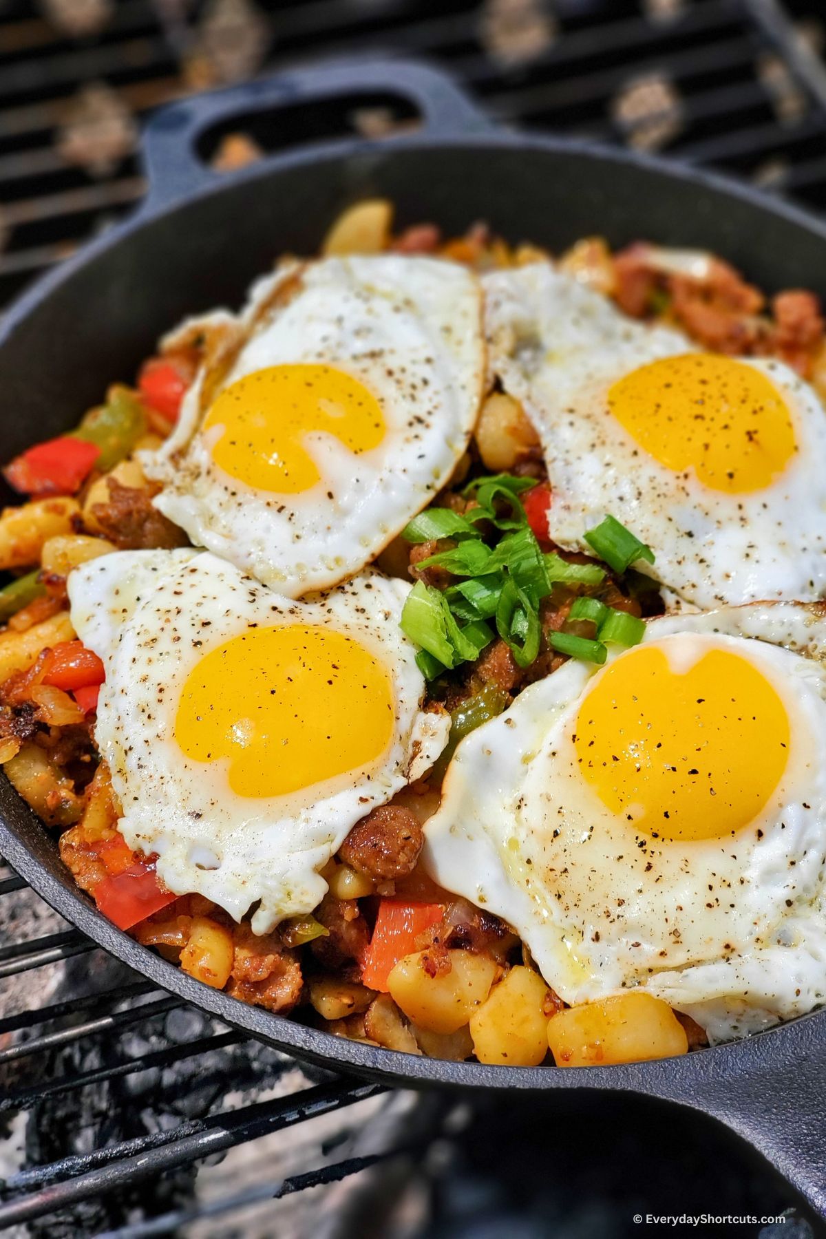 eggs on top of hash in a skillet