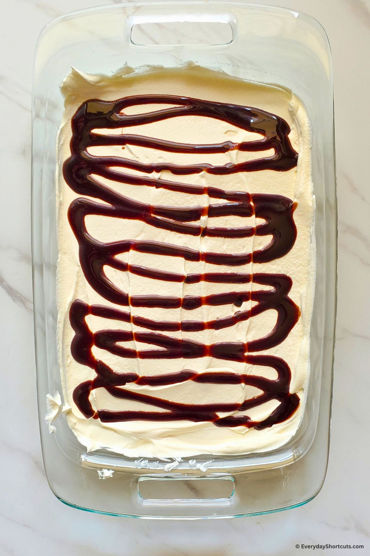 chocolate syrup drizzled on whipped topping