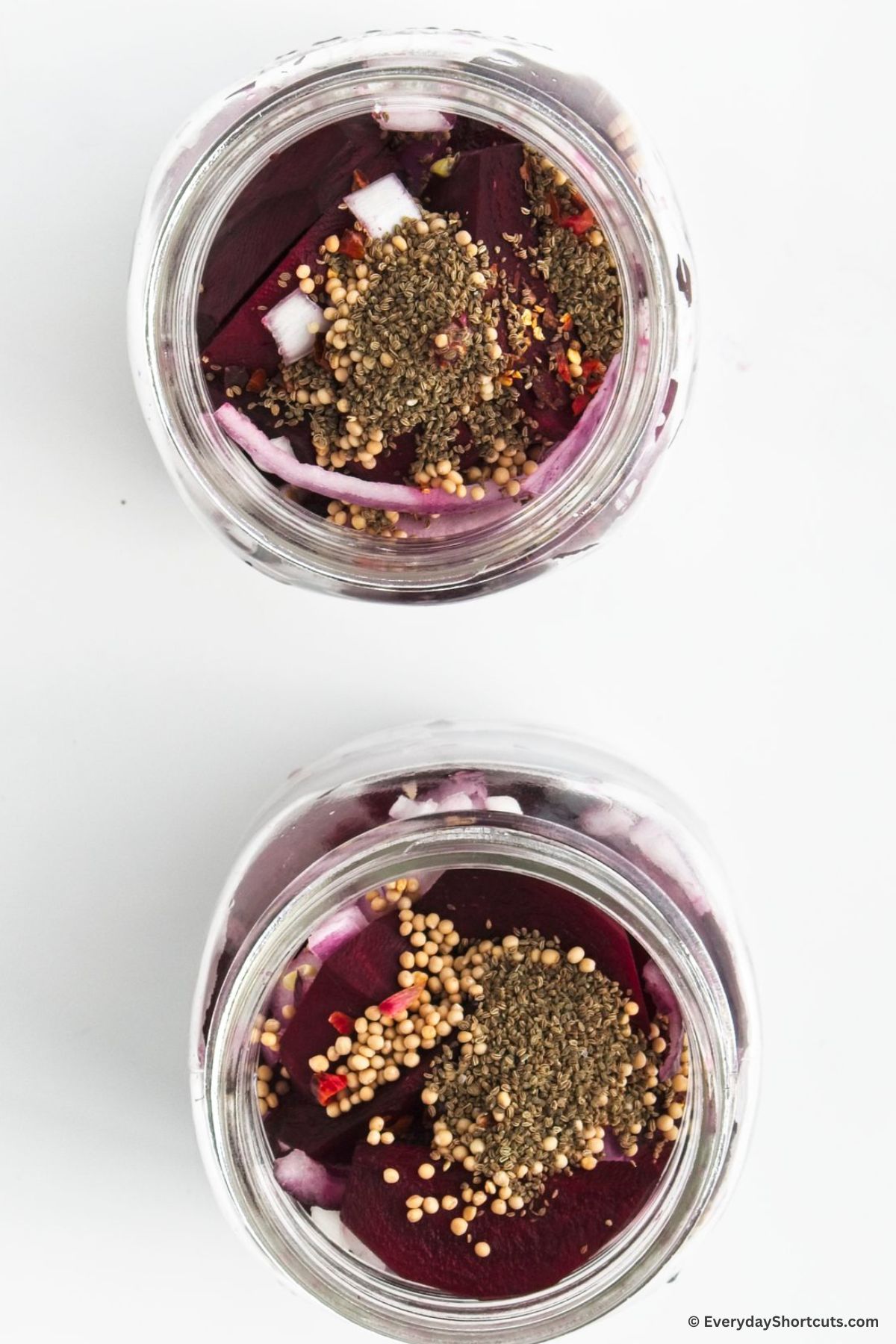 pickling seasoning in mason jars with beets and onions