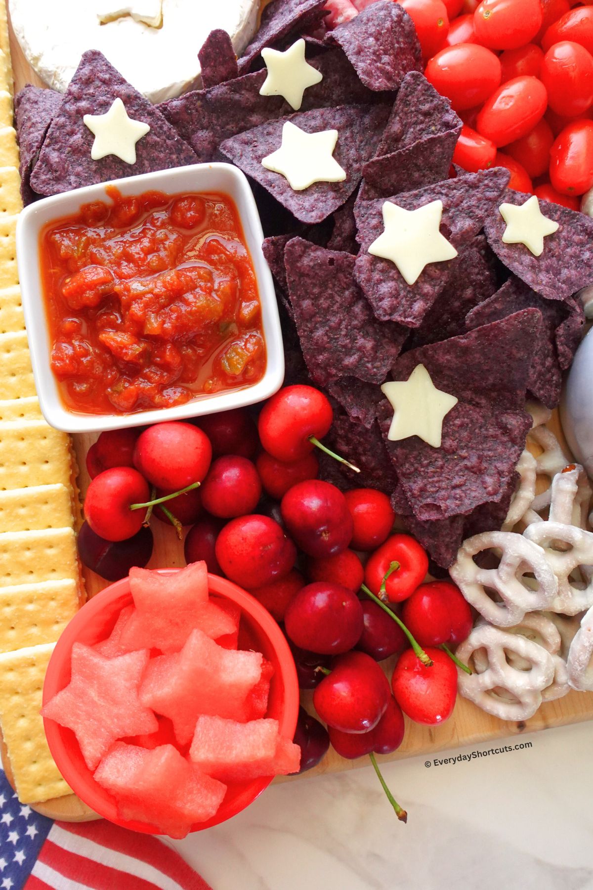 salsa chips and star shaped cheeses on a patriotic board