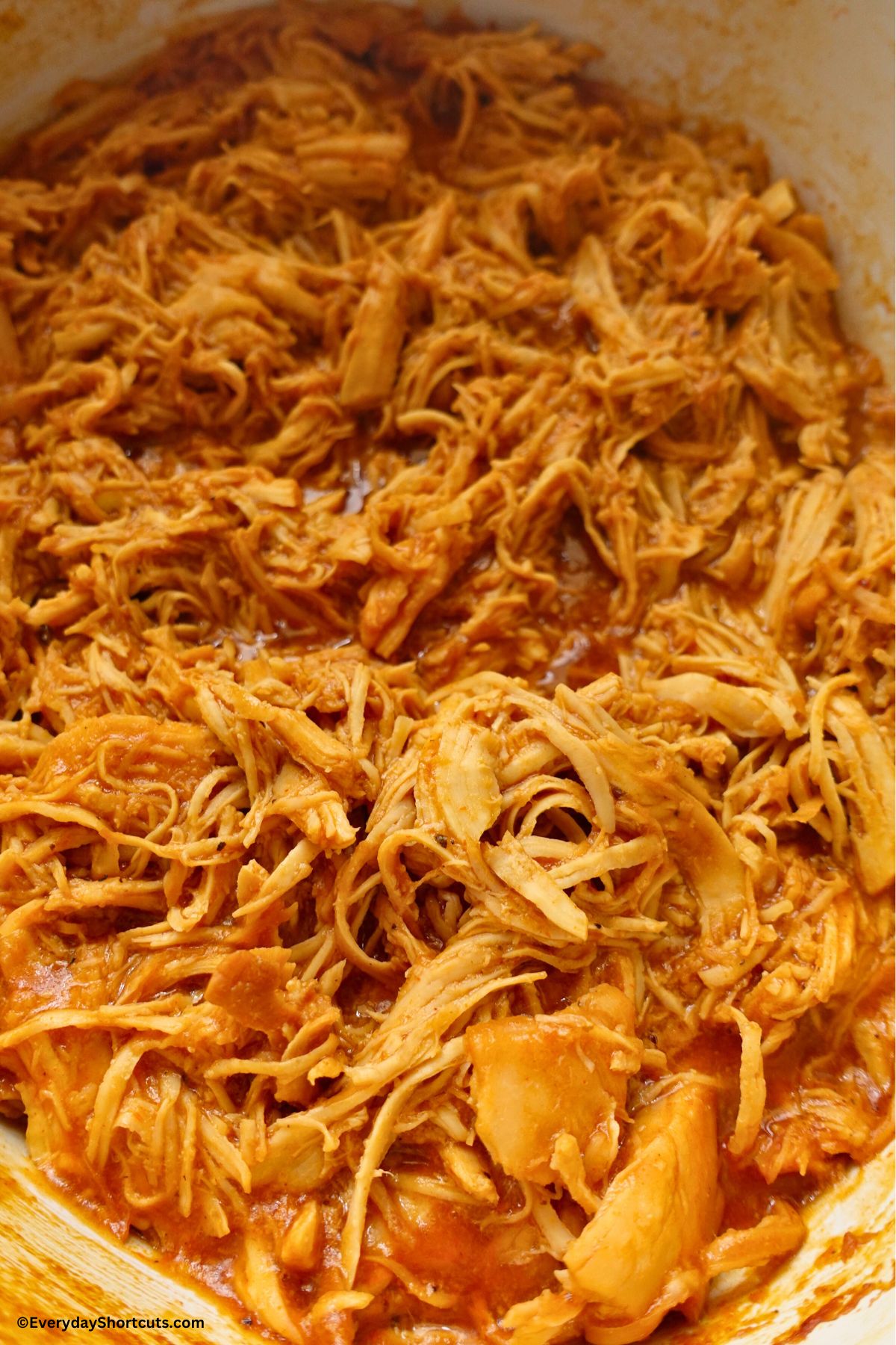 shredded cooked bbq chicken in a crock pot