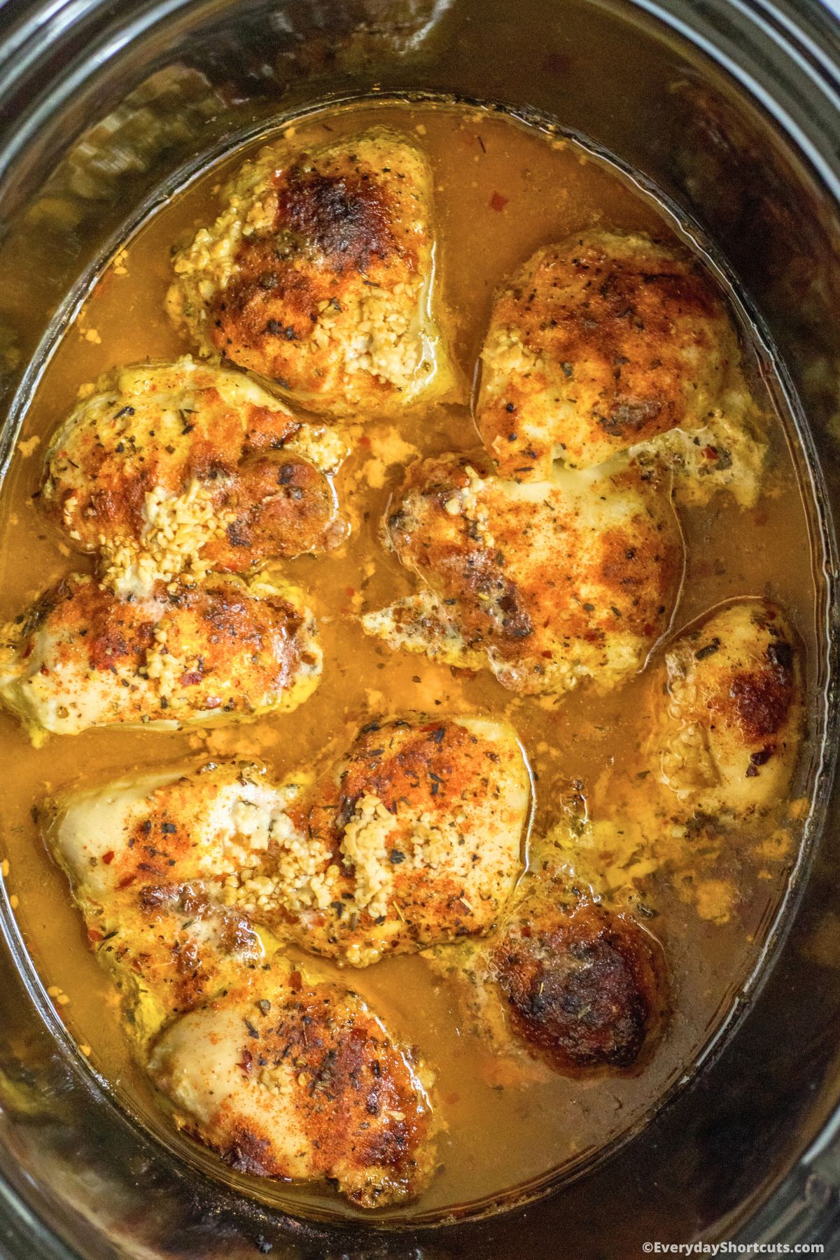 chicken thighs cooking in a slow cooker