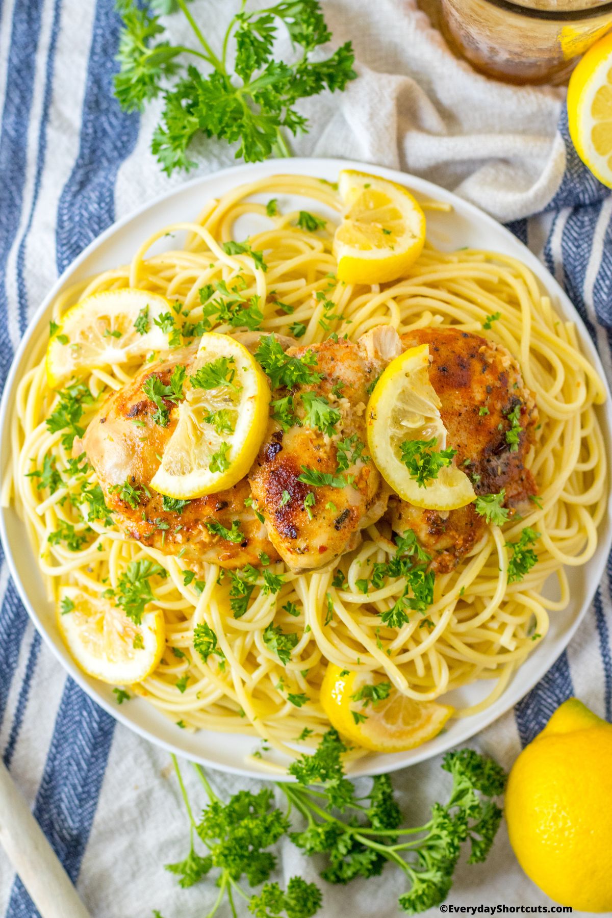 Lemon Garlic Butter Chicken Thighs on a plate with noodles