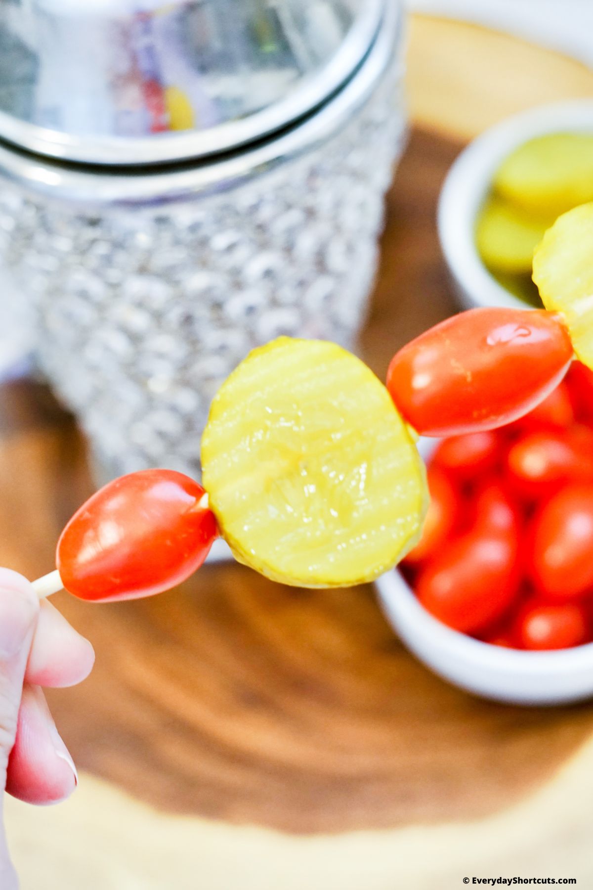 pickle chips and cherry tomatoes on a skewer stick