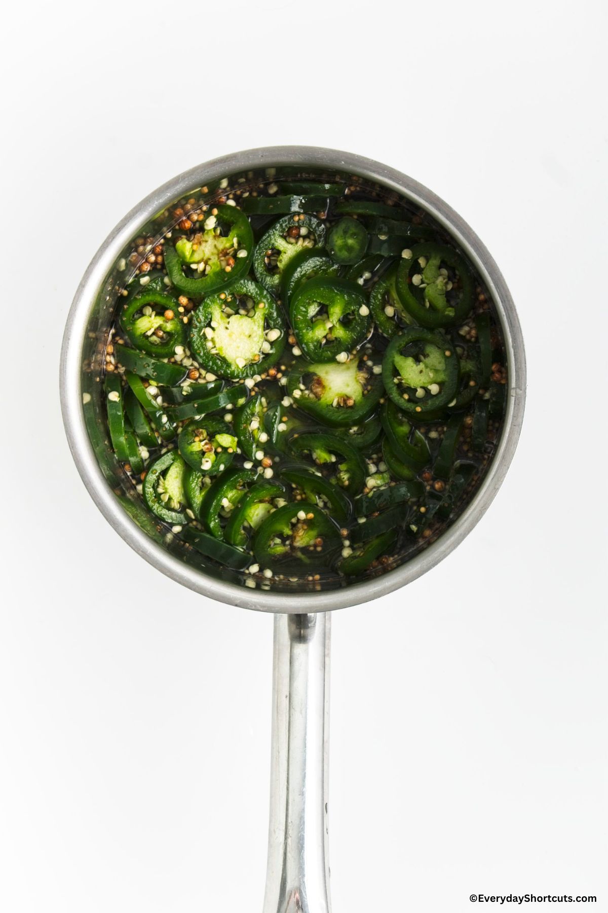 candied syrup seasonings and sliced jalapenos in a saucepan