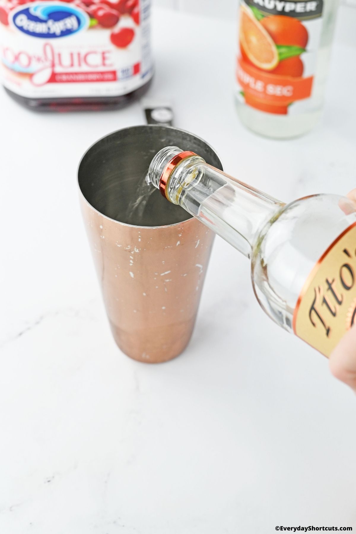 add titos vodka to a cocktail shaker