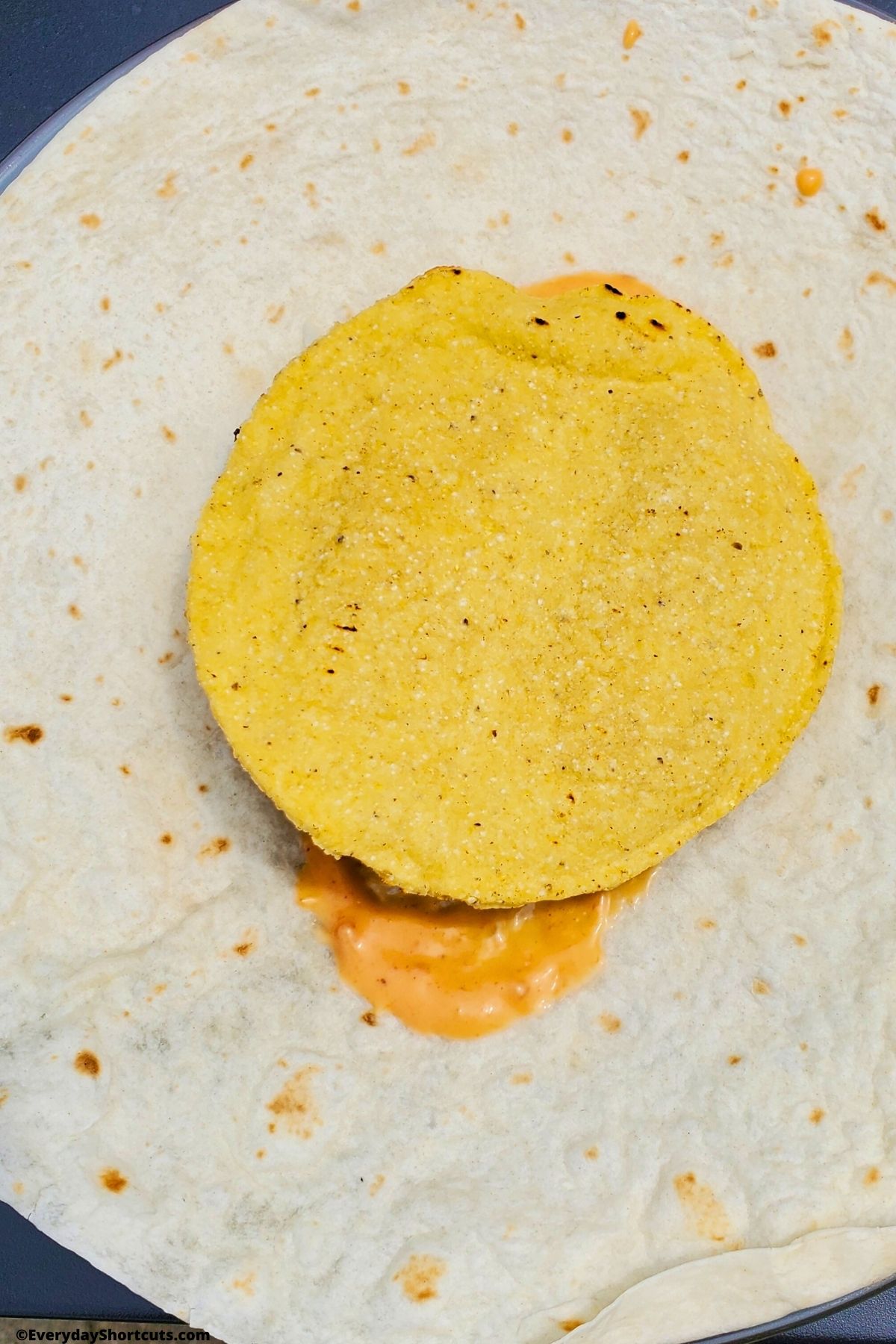 crunchy tortilla on top of cheeseburger on a tortilla