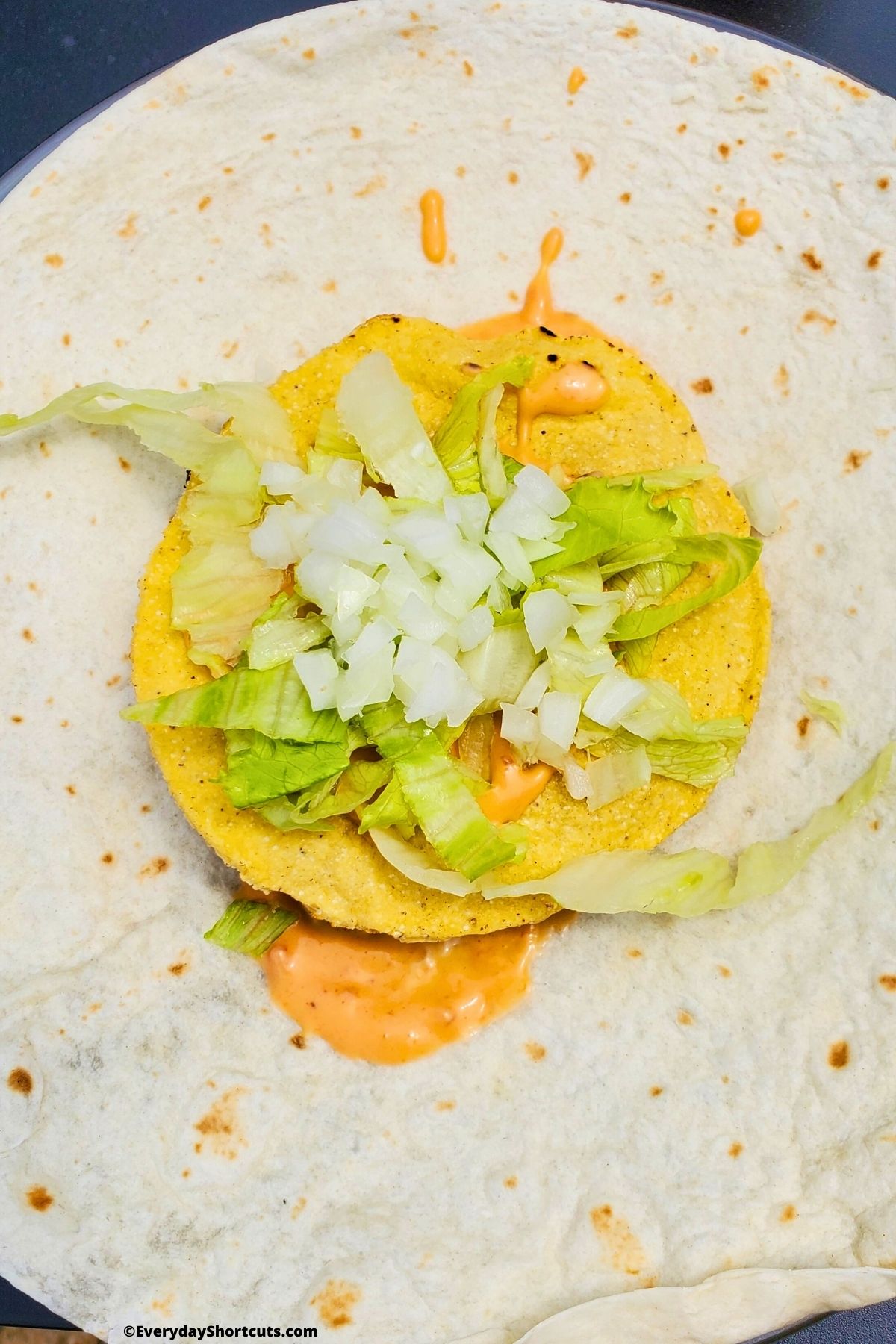 lettuce and onions topping on crunchy tortilla
