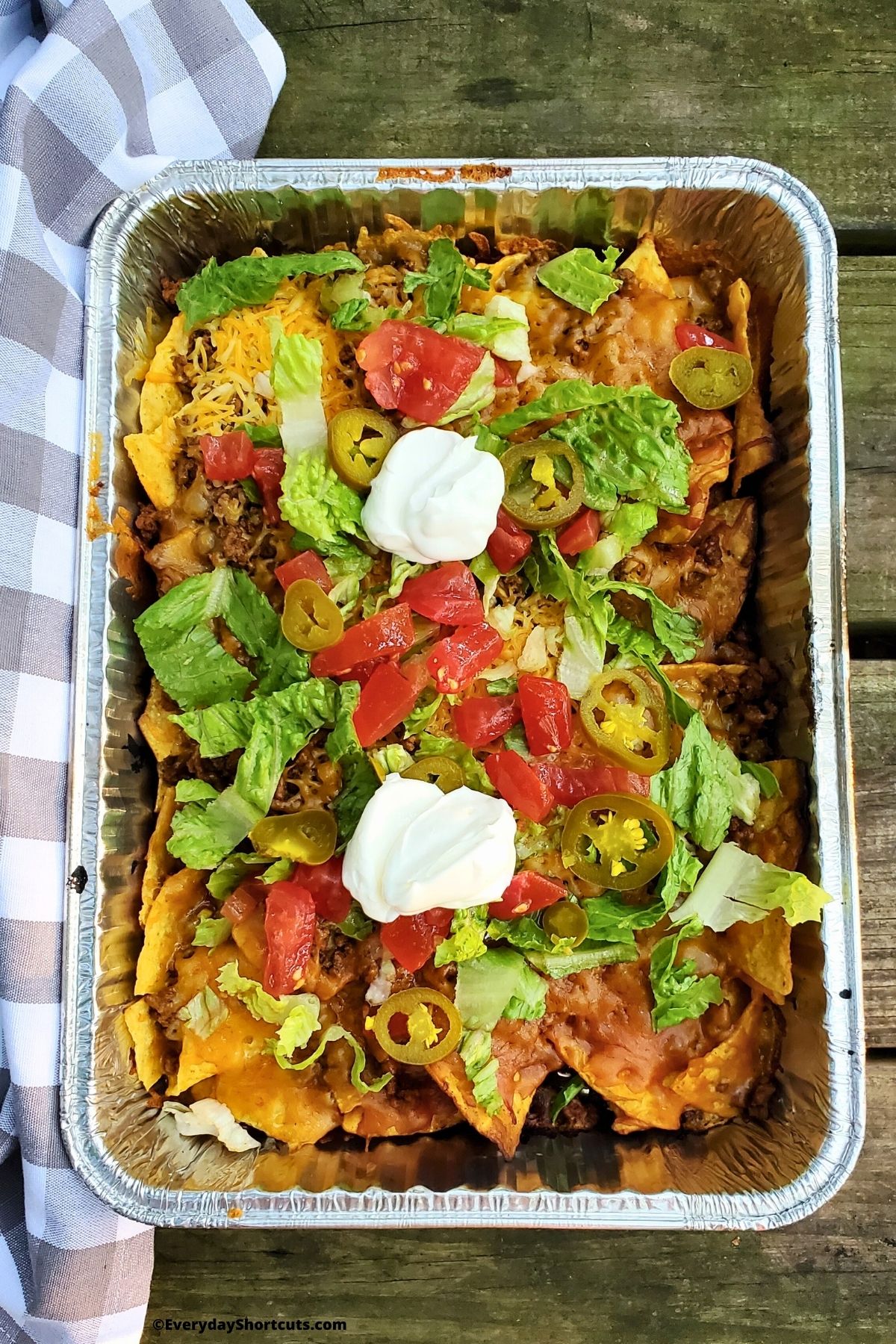 cooked nachos in a foil pan