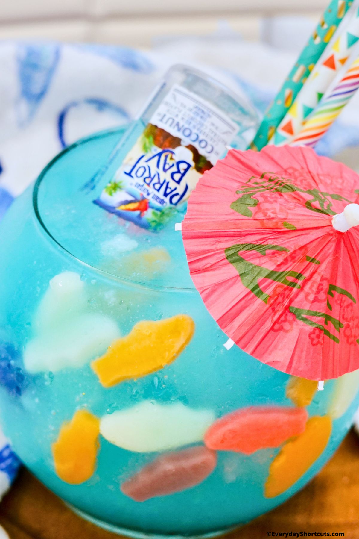 fish bowl with parrot rum bottle and umbrella