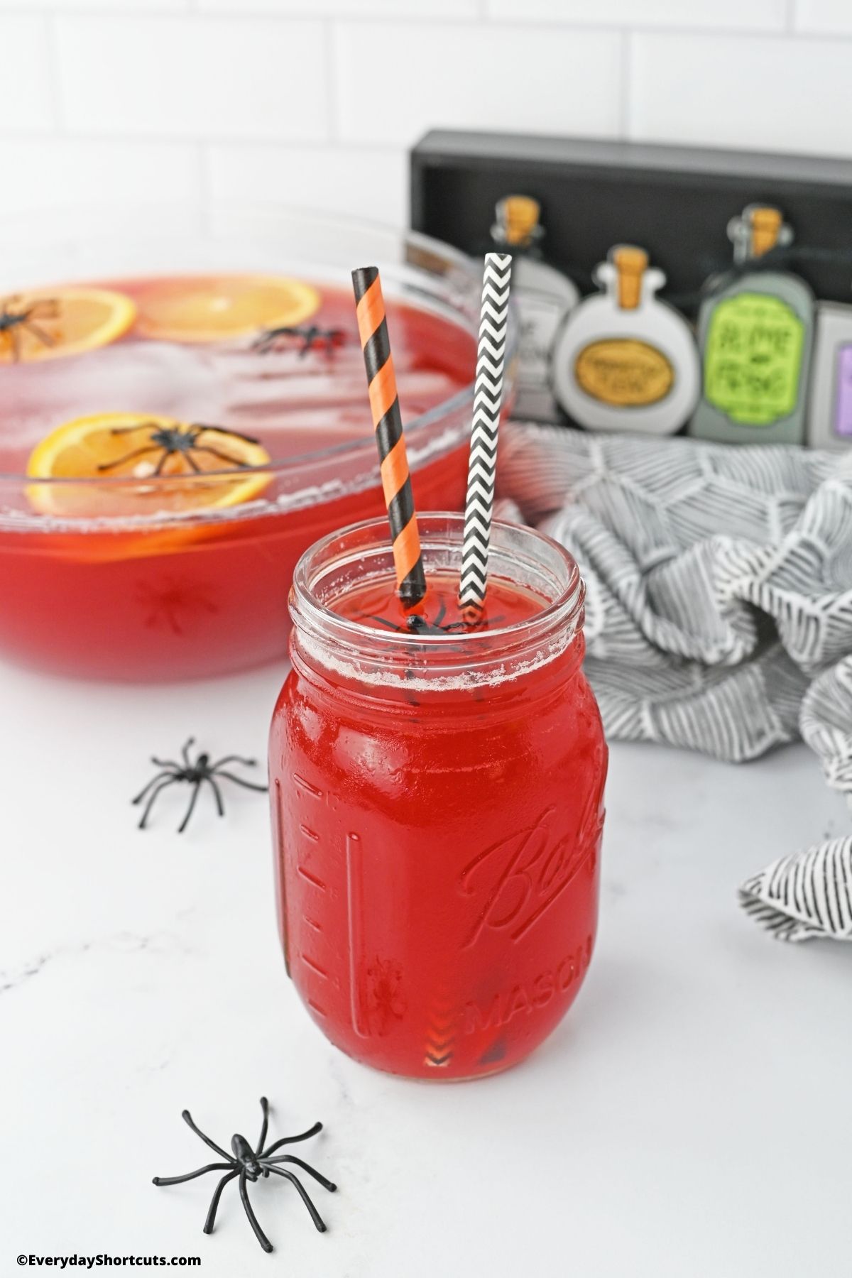 alcoholic punch in a glass with plastic spiders for Halloween
