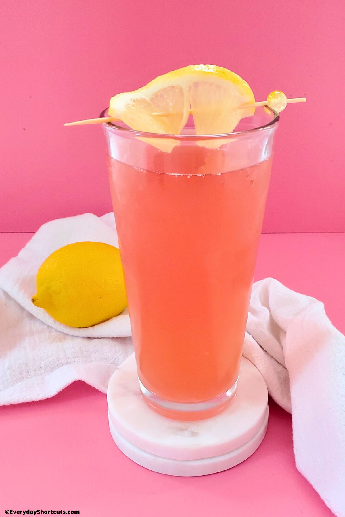 porch crawler with pink lemonade in a glass