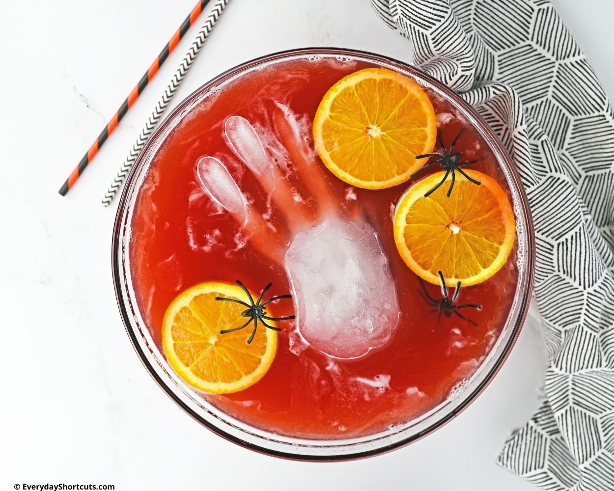 ice hand floating in red vodka punch