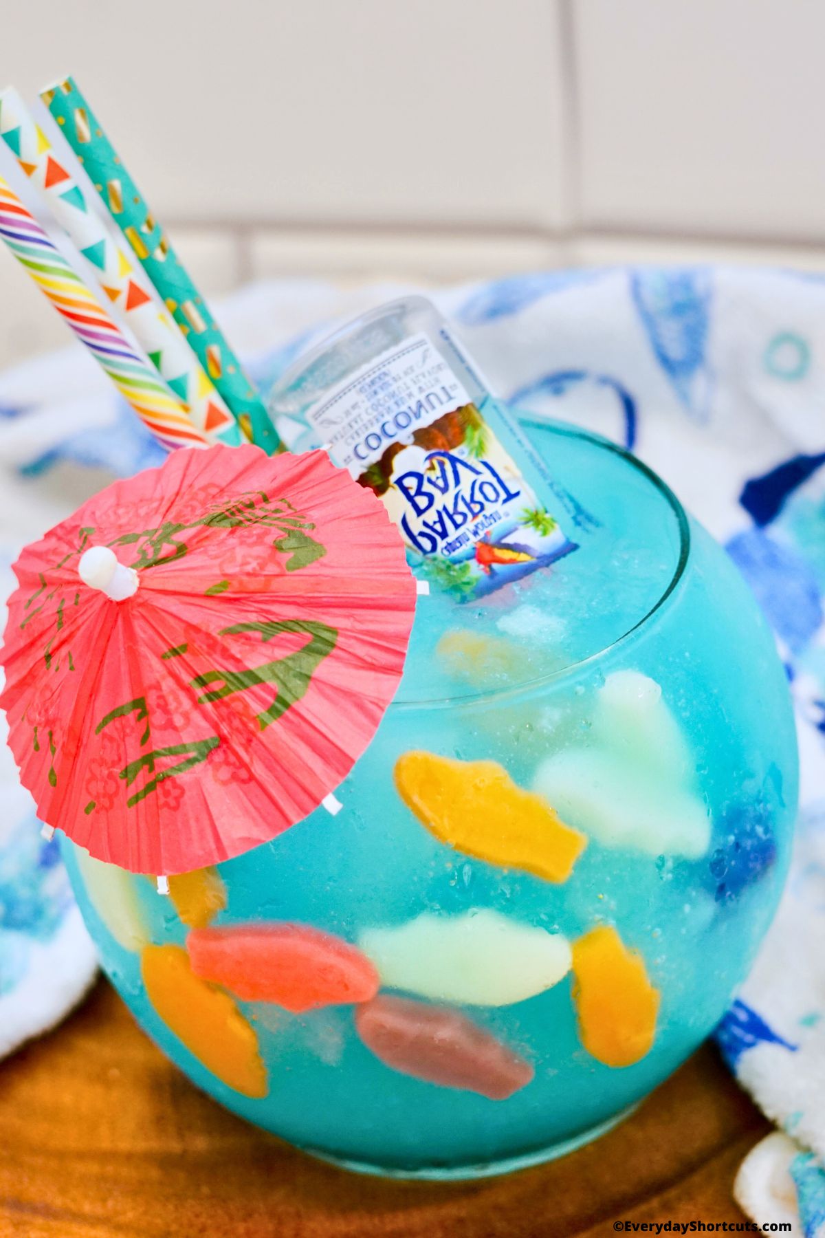 fish bowl drink with umbrella and straws