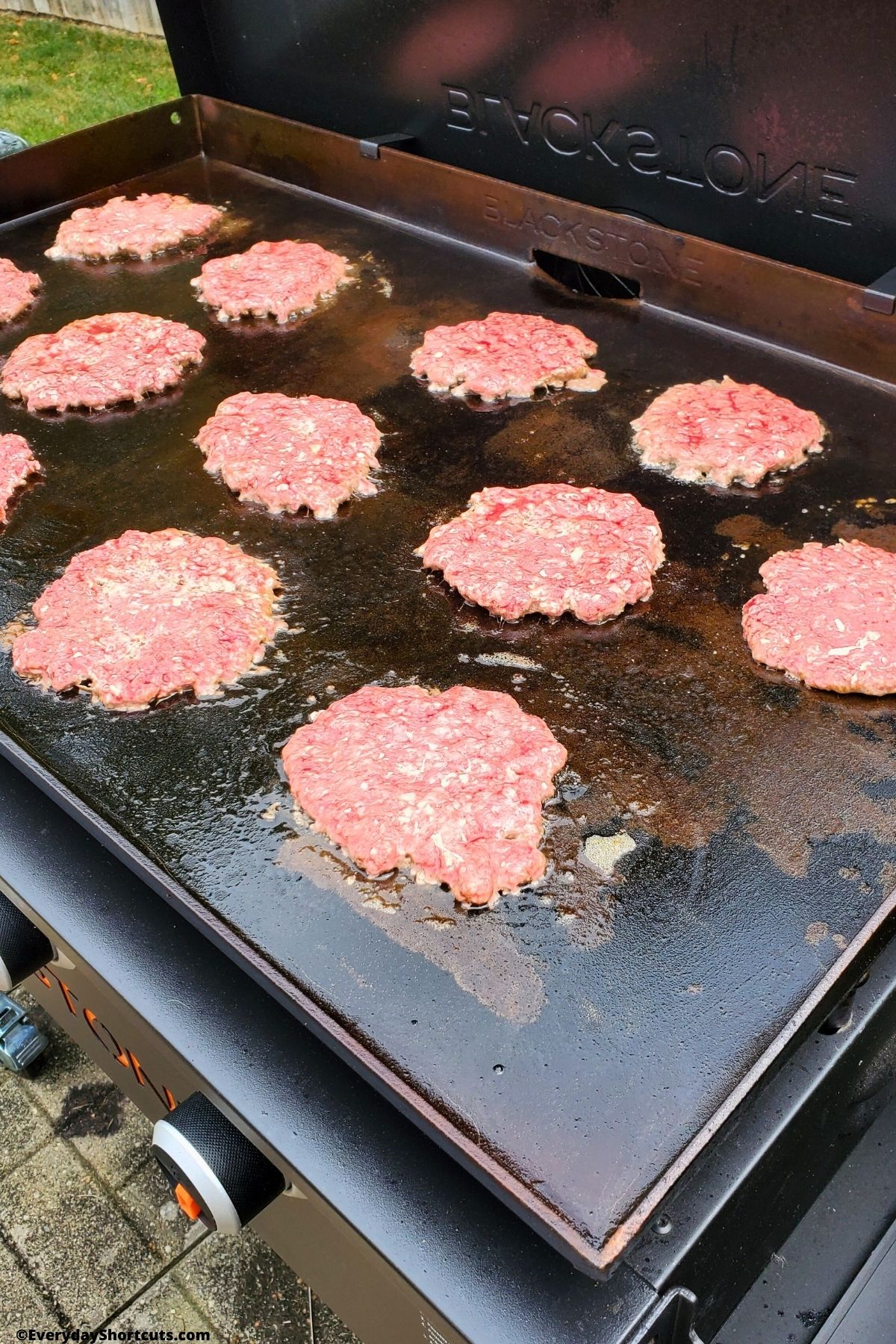 smash burgers cooking on a blackstone griddle