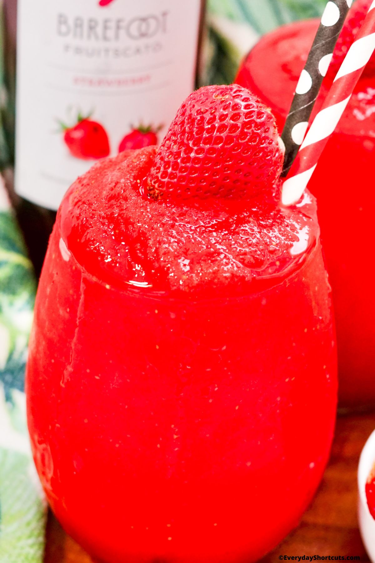 frozen wine drink in a glass garnished with a strawberry