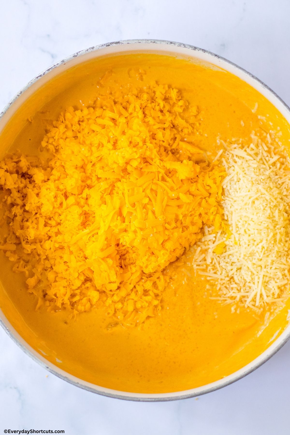 pumpkin mixture and shredded cheese in a pan
