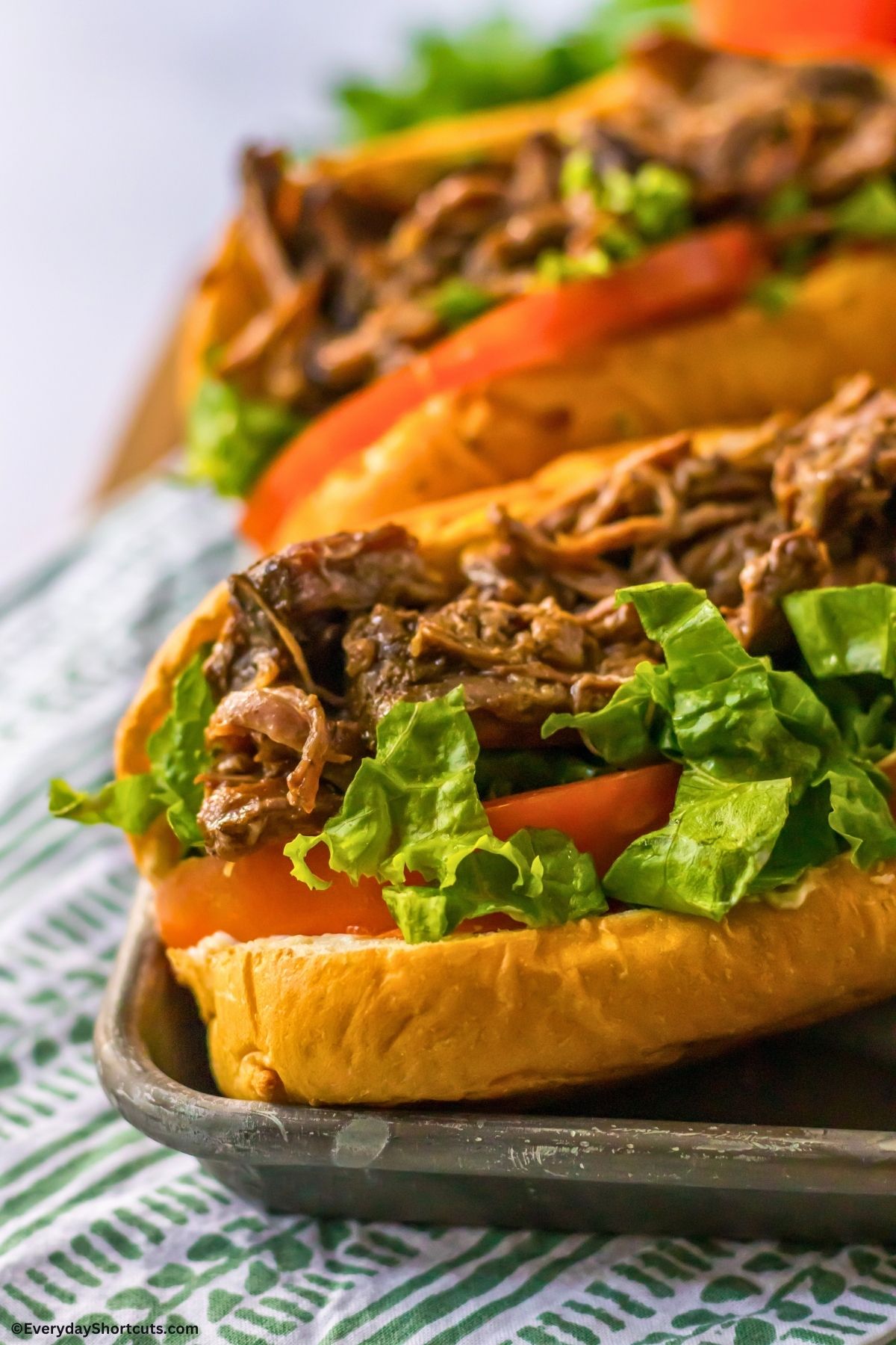 shredded roast beef and toppings on a sub bun