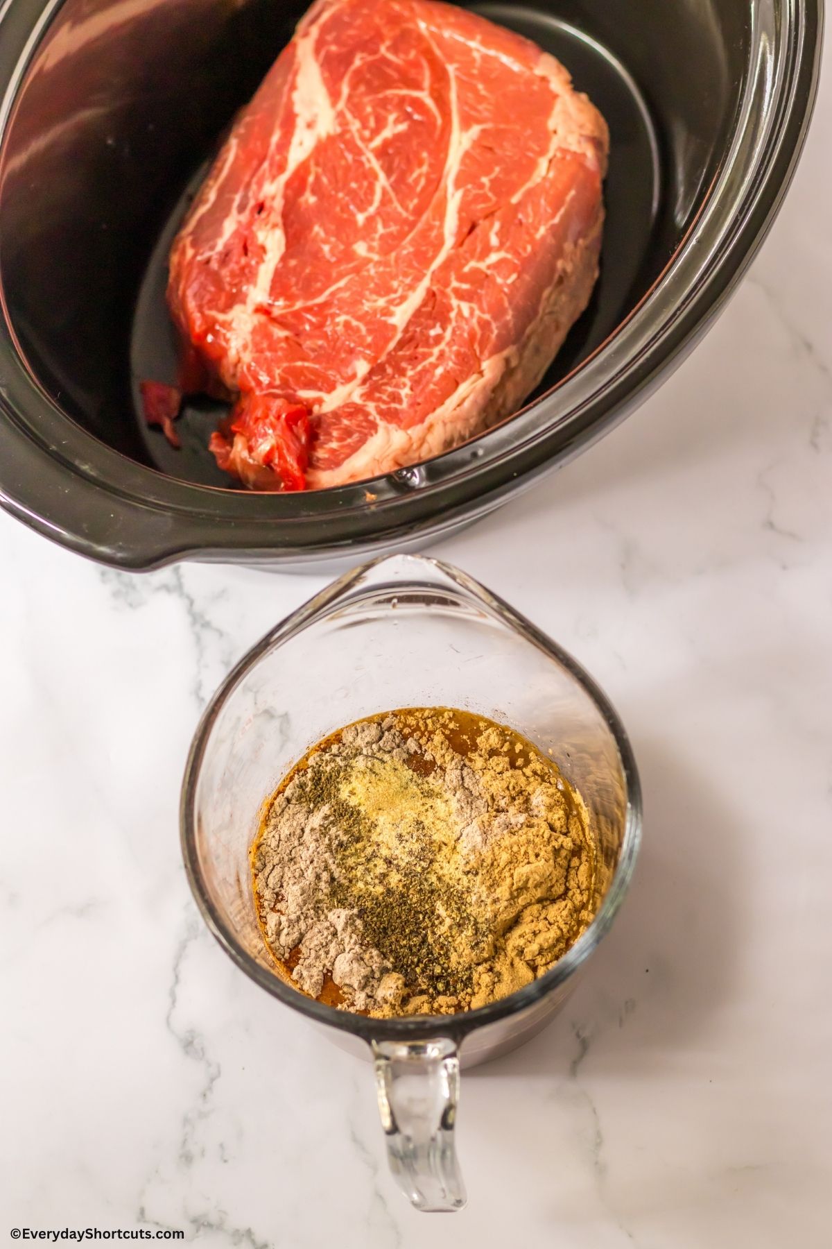 brown gravy mix in a cup and chuck roast in slow cooker