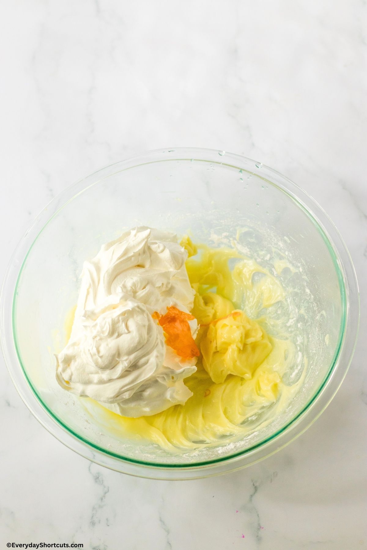 cream cheese mixture with yellow food coloring in a bowl