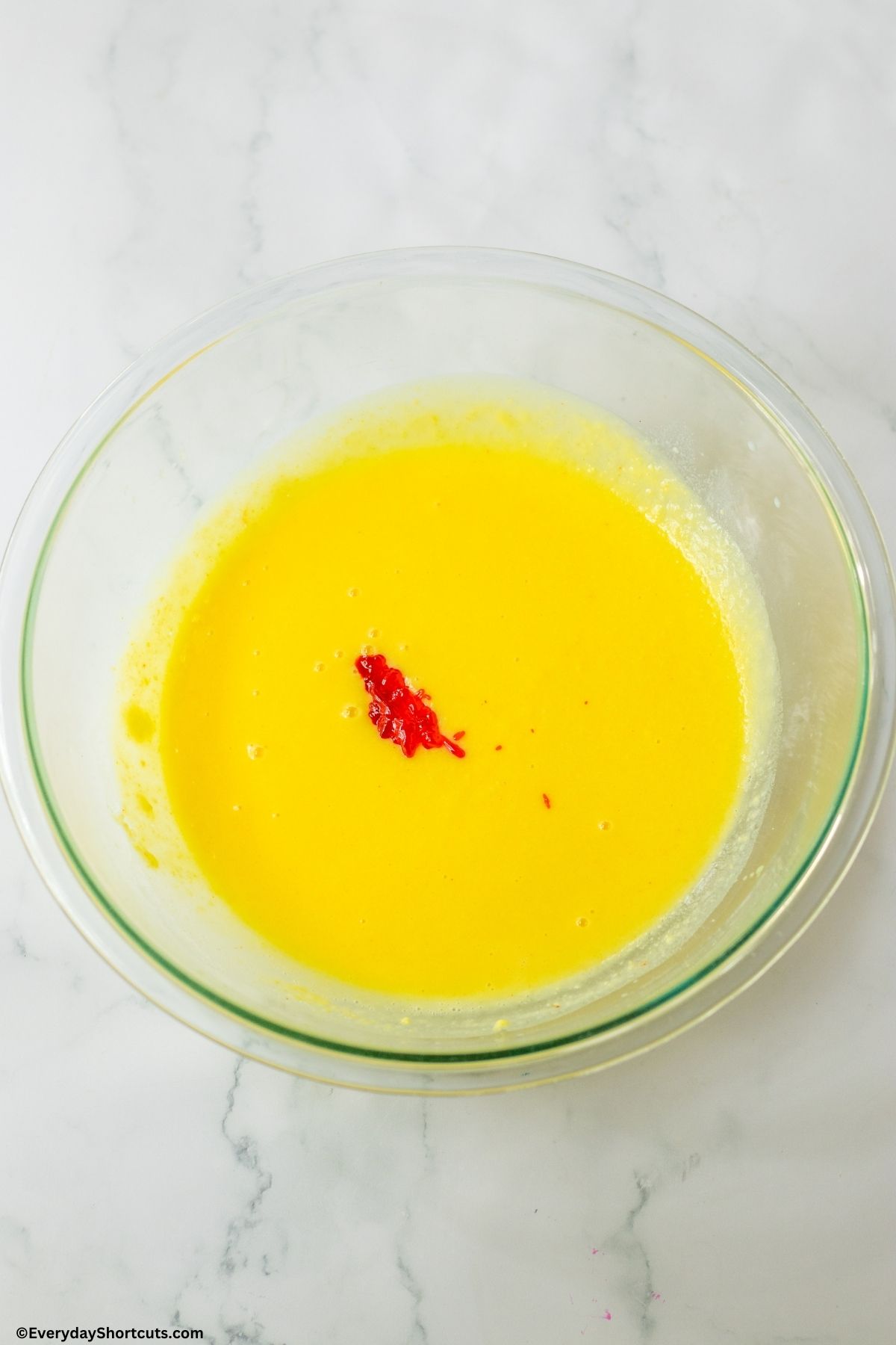 pudding mixture with orange food coloring in a bowl