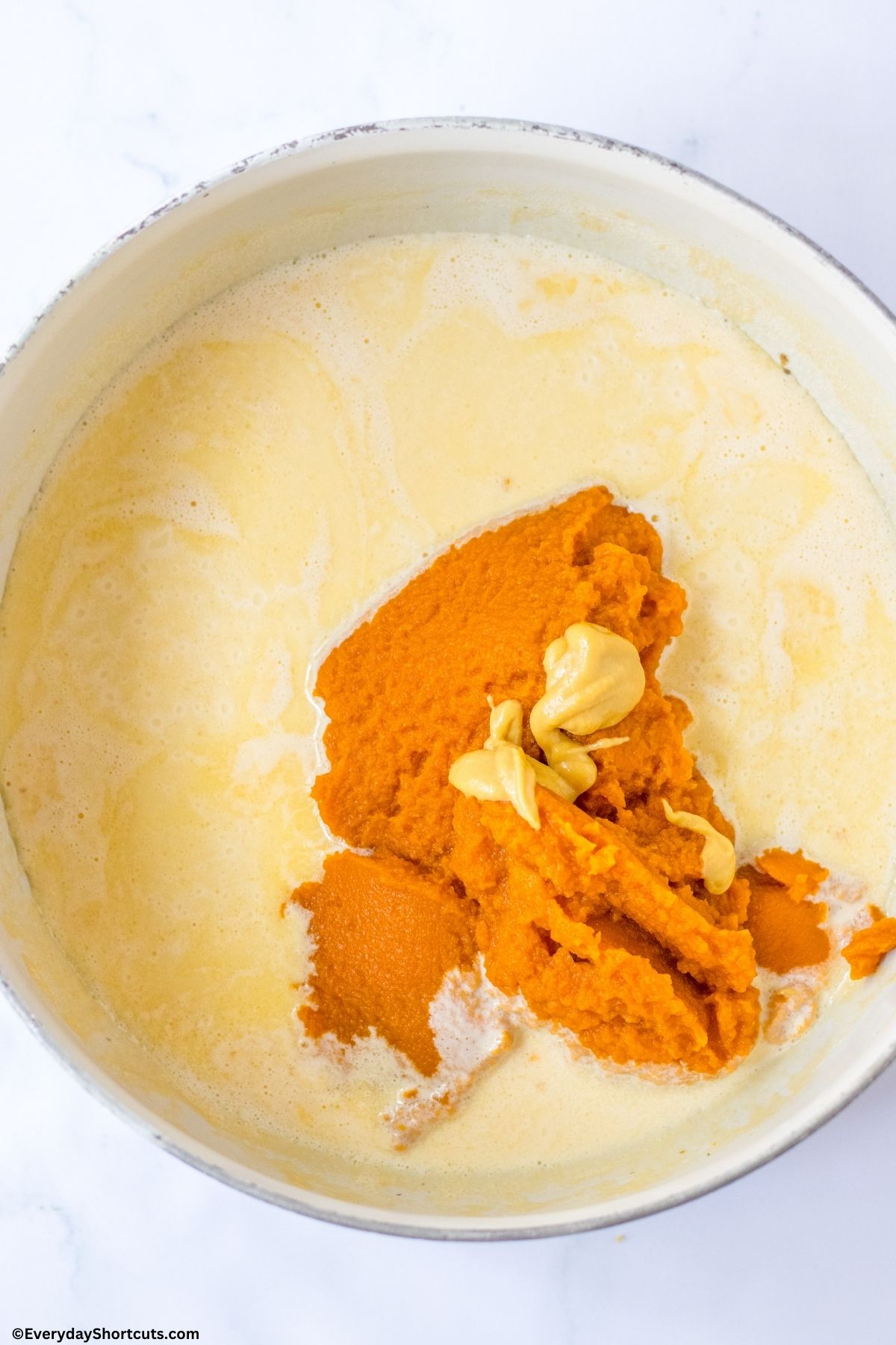 butter and pumpkin puree in a pan