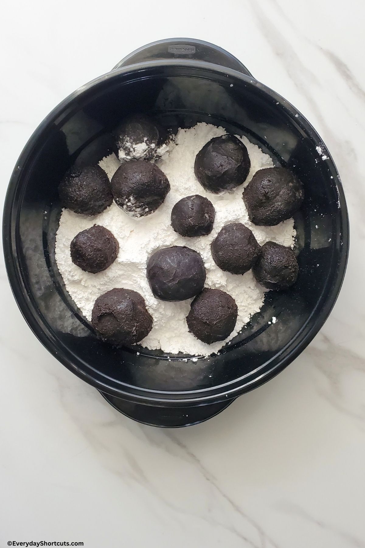 Oreo balls with powder sugar in a bowl