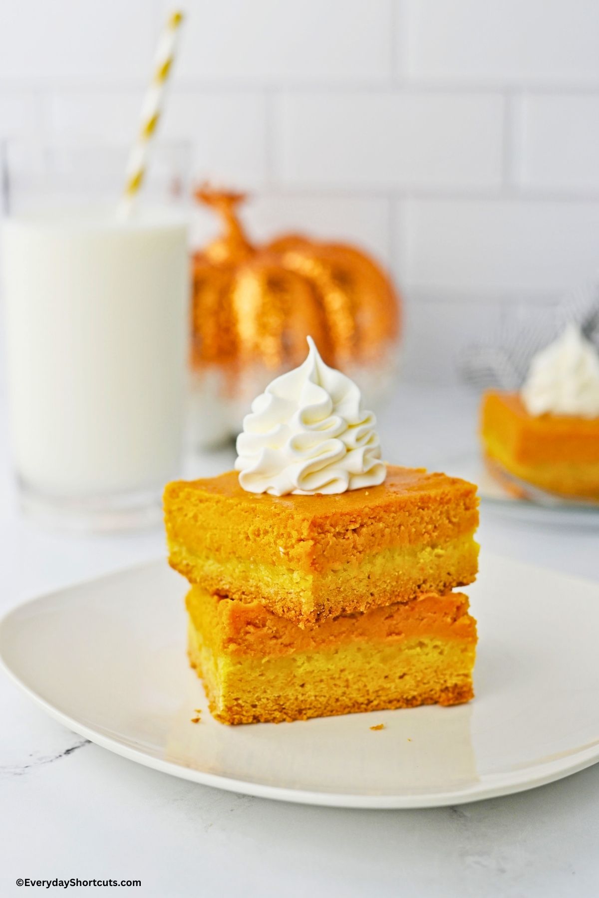 pumpkin gooey bars with whipped cream on a plate
