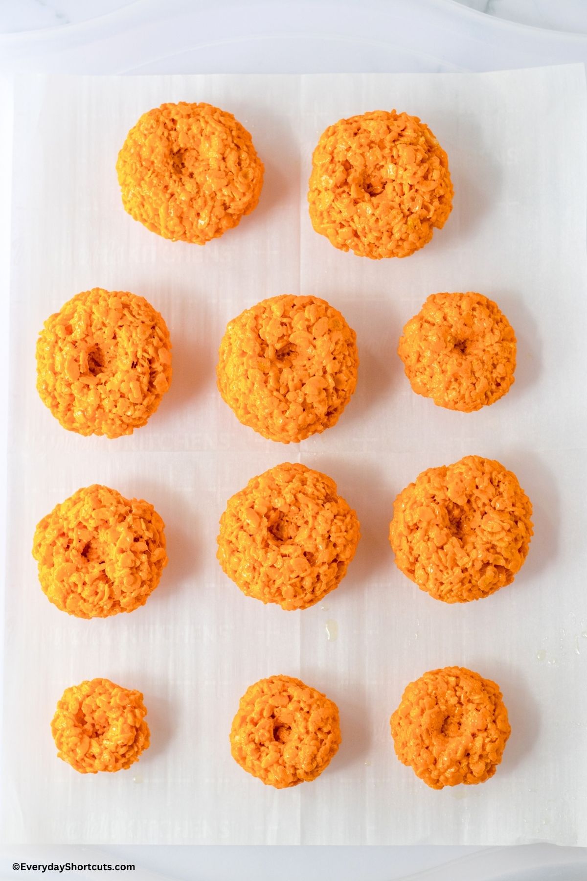 cereal treats formed into balls on parchment paper