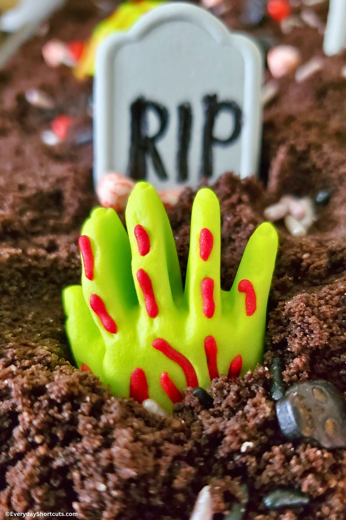zombie hand and tombstone in chocolate cake