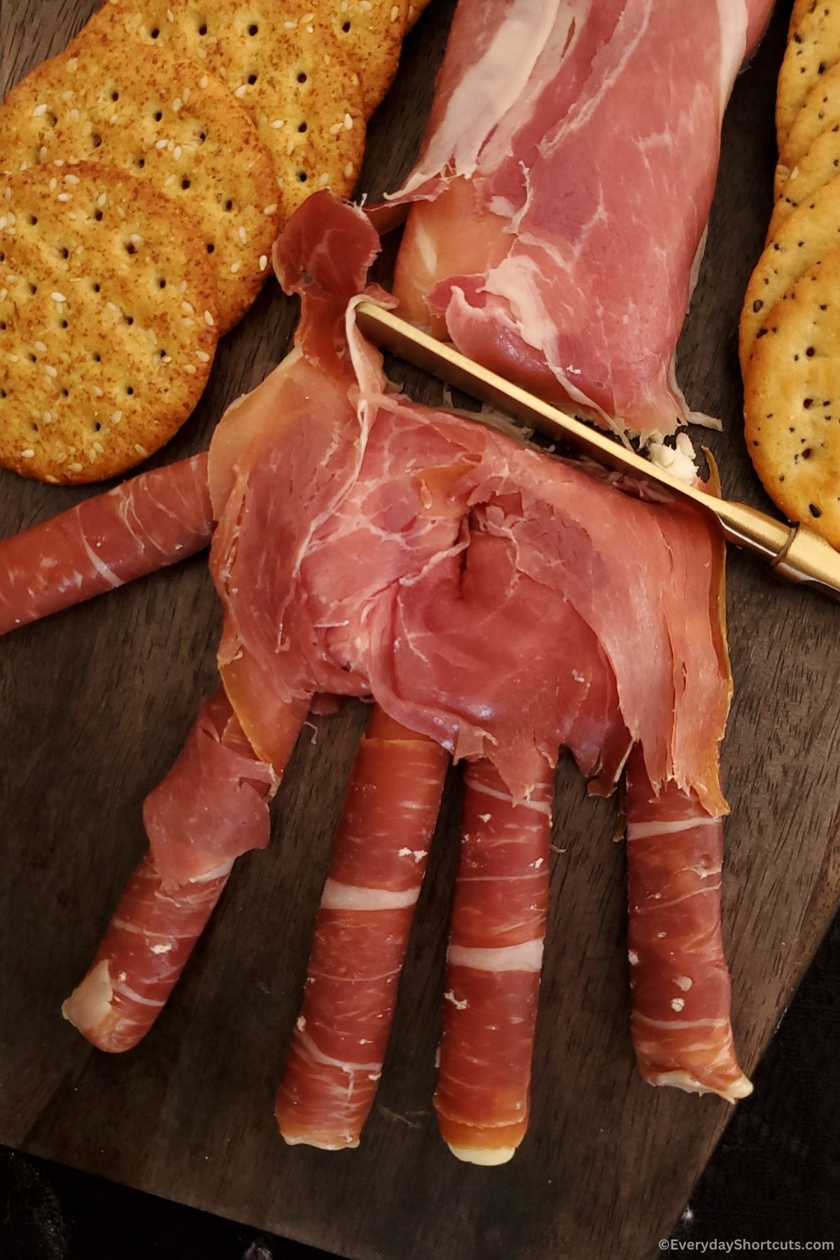 prosciutto Halloween hand on a coffin shaped platter