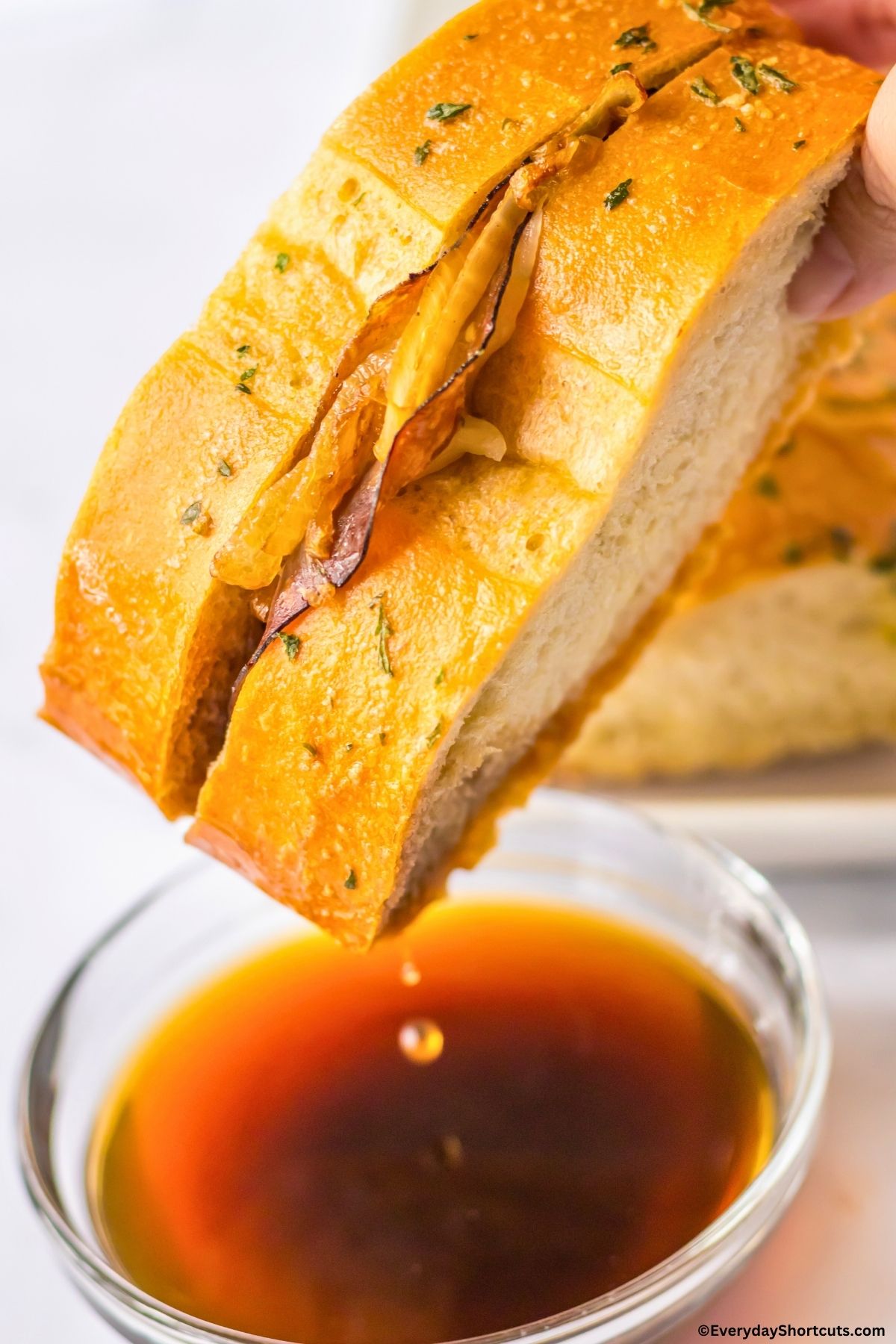 french dip bread dipped into consomme