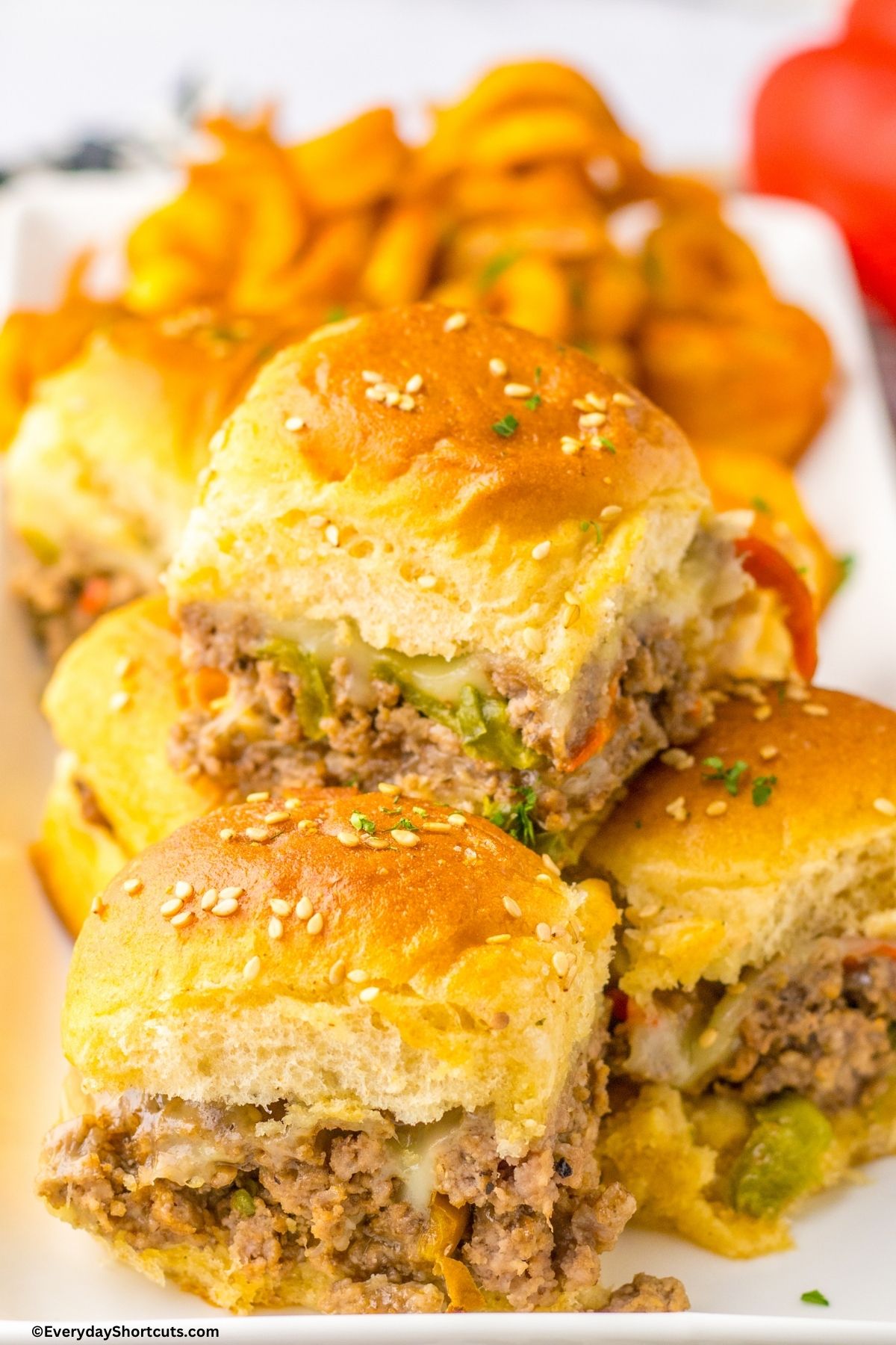 platter of ground beef Philly cheesesteak sliders with fries