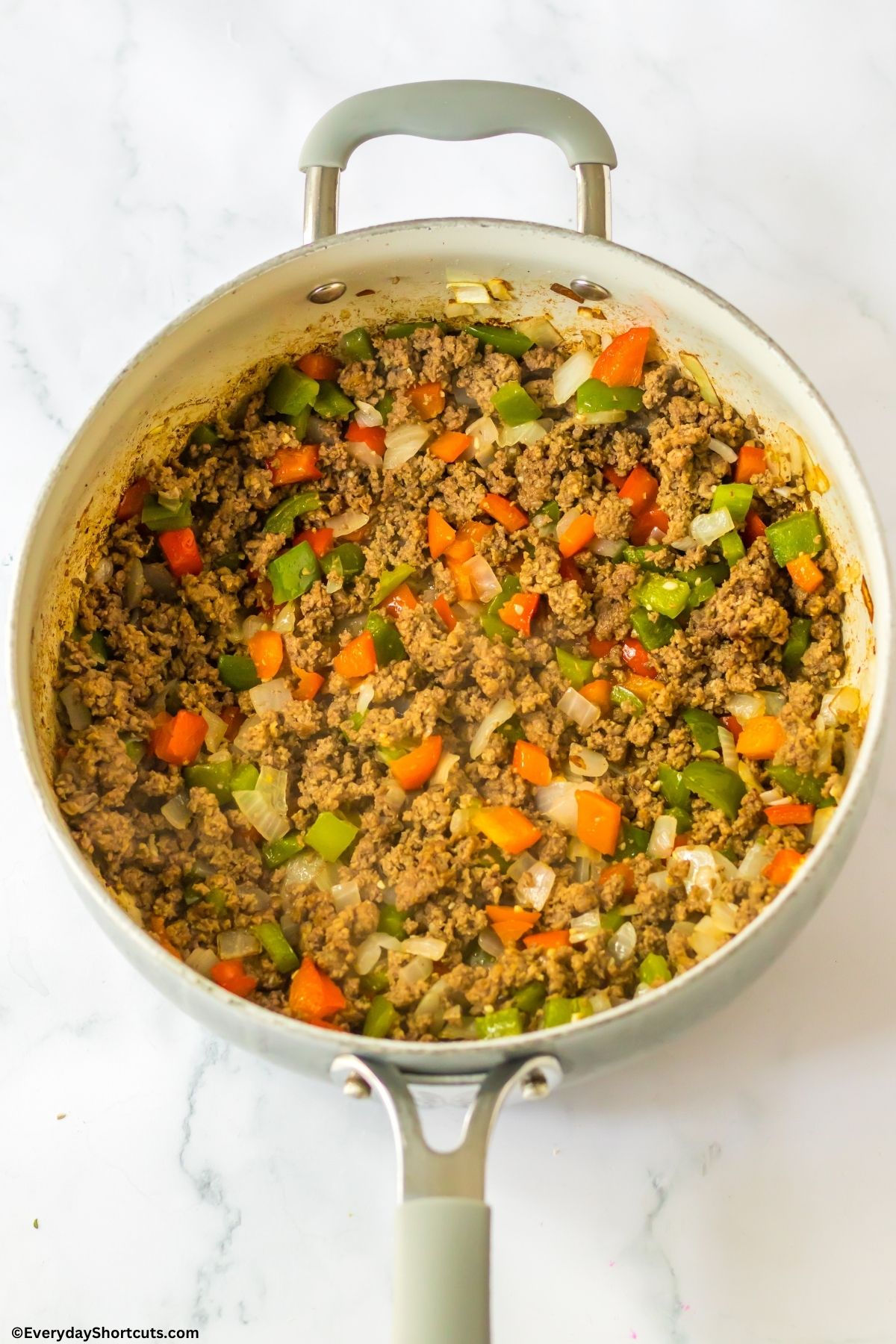ground beef onions and peppers in a pan
