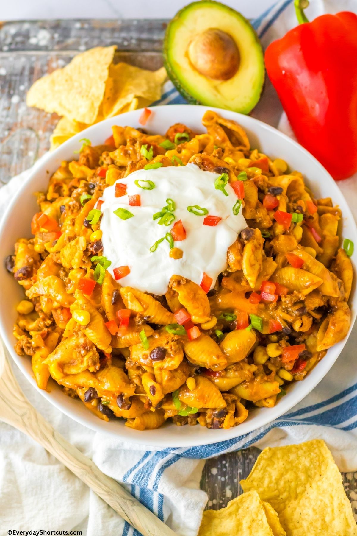 pasta with taco fillings in a bowl and sour cream on top
