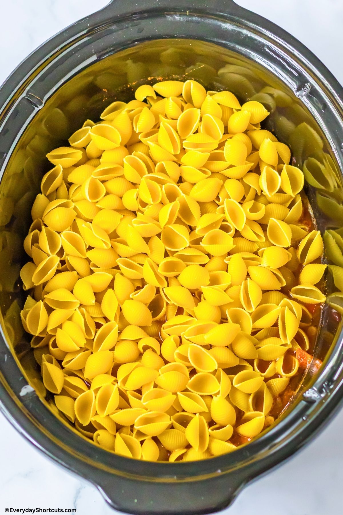 pasta shells in a crock pot with taco fillings