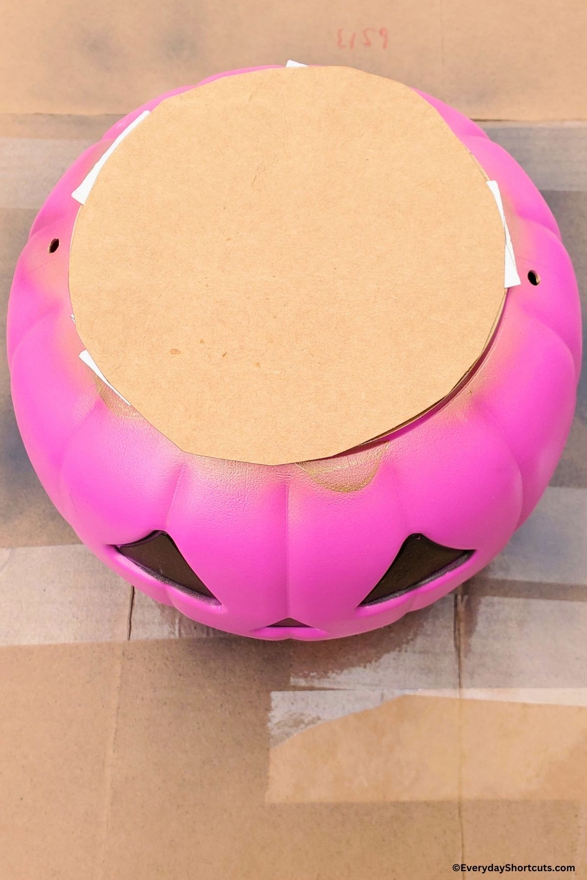 cardboard on top of plastic pumpkin