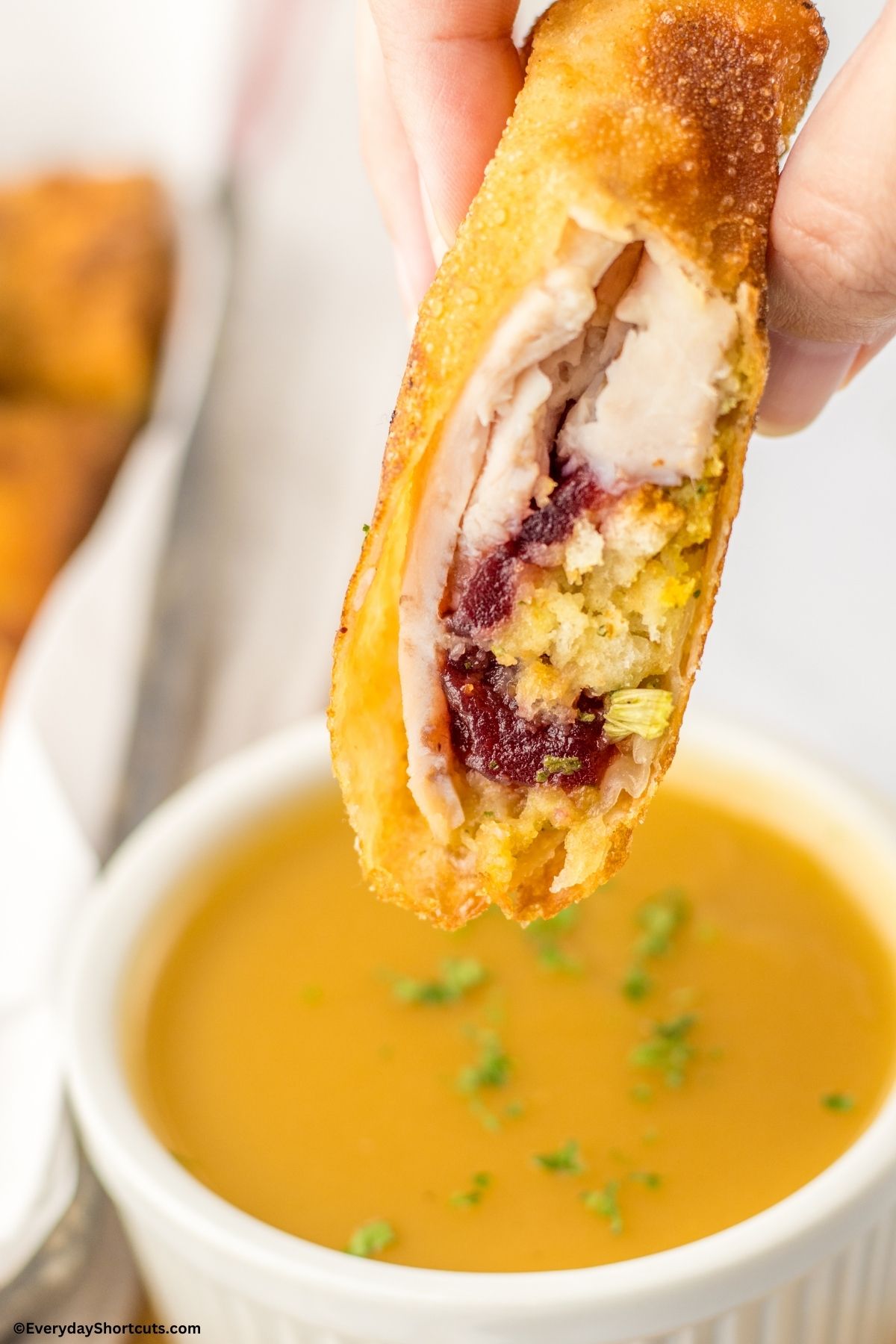 dipping a Thanksgiving egg roll in gravy