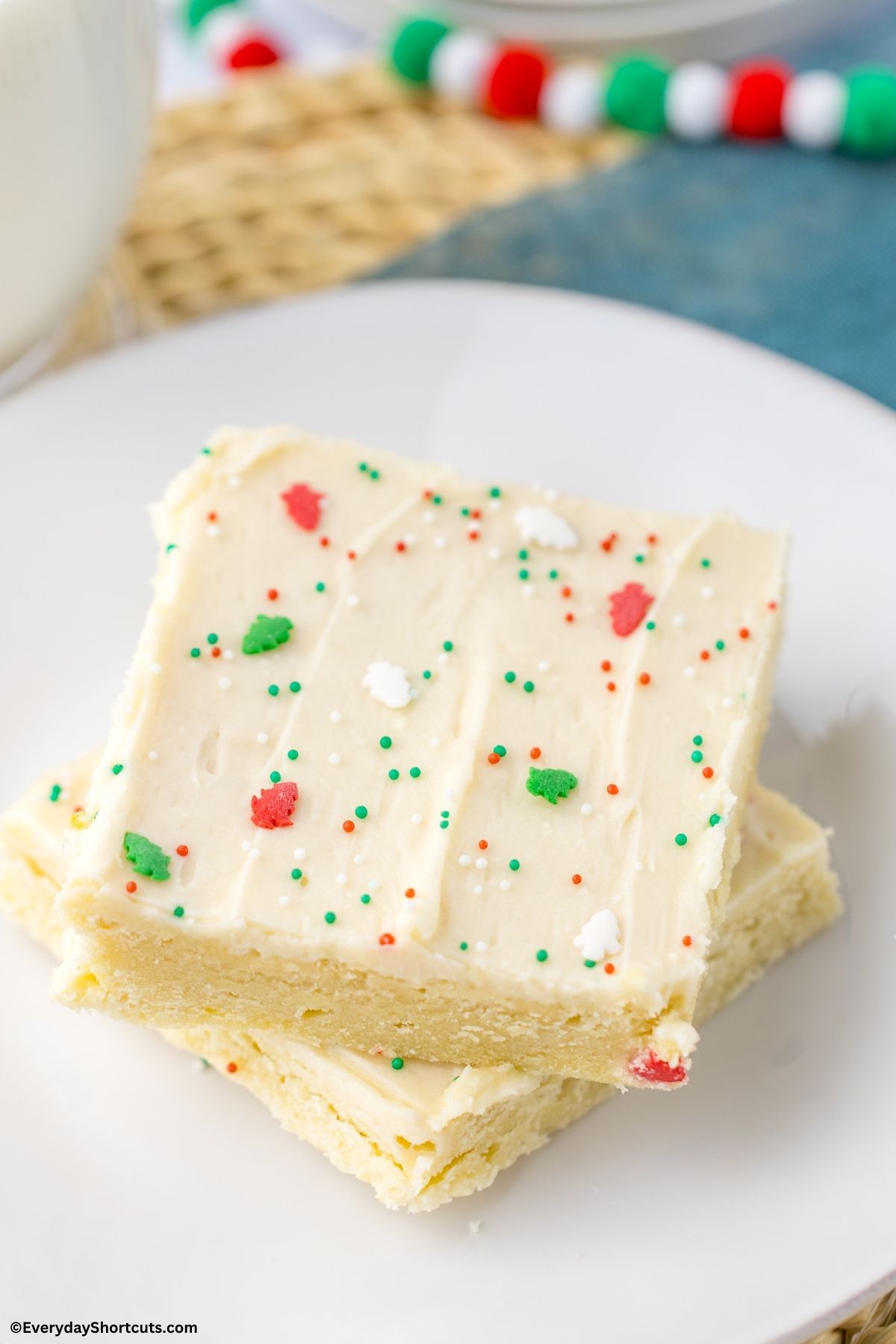 sugar cookie bars on a plate with Christmas sprinkles