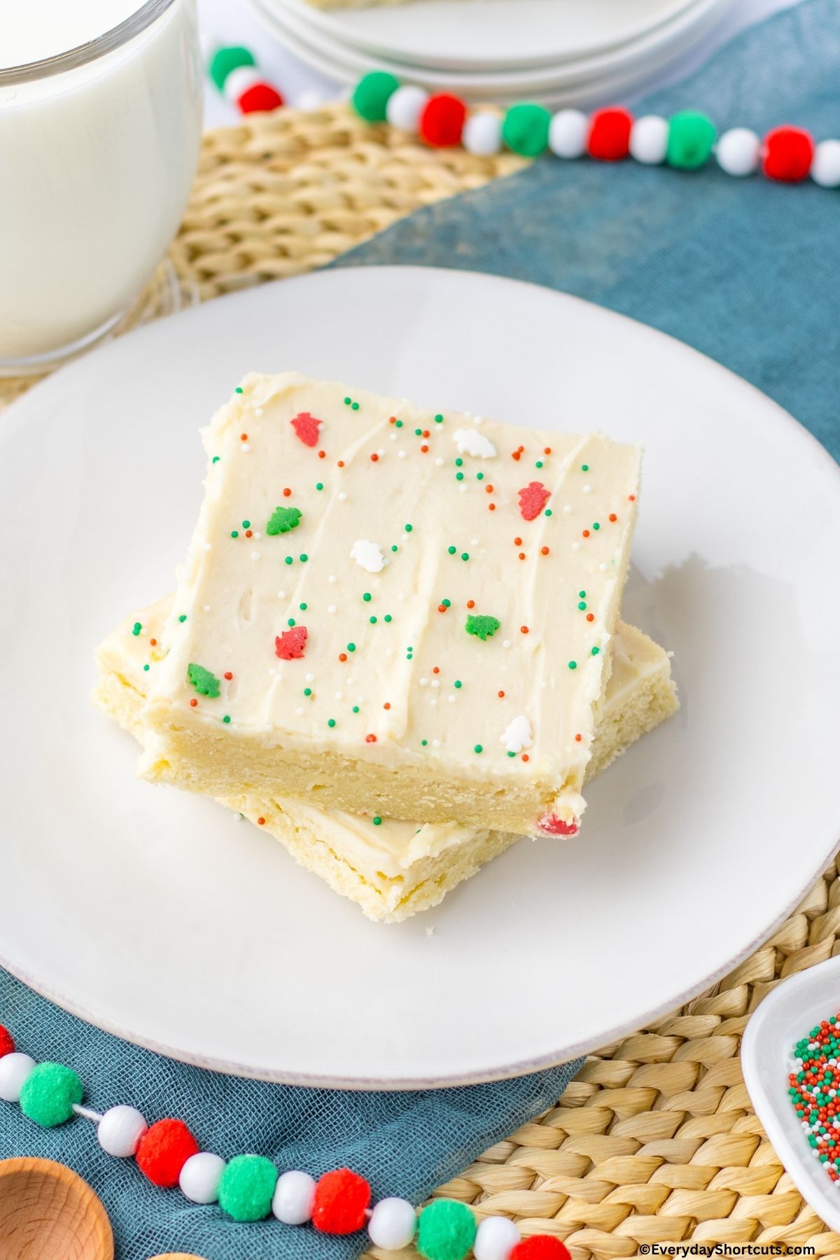 sugar cookies bars with Christmas themed sprinkles on a plate