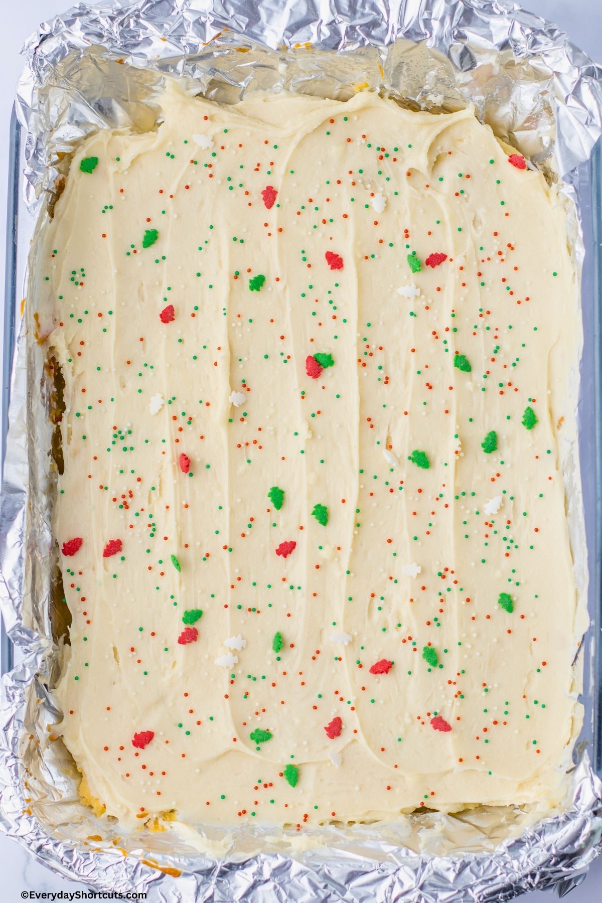 frosted sugar cookies with Christmas sprinkles in a baking dish