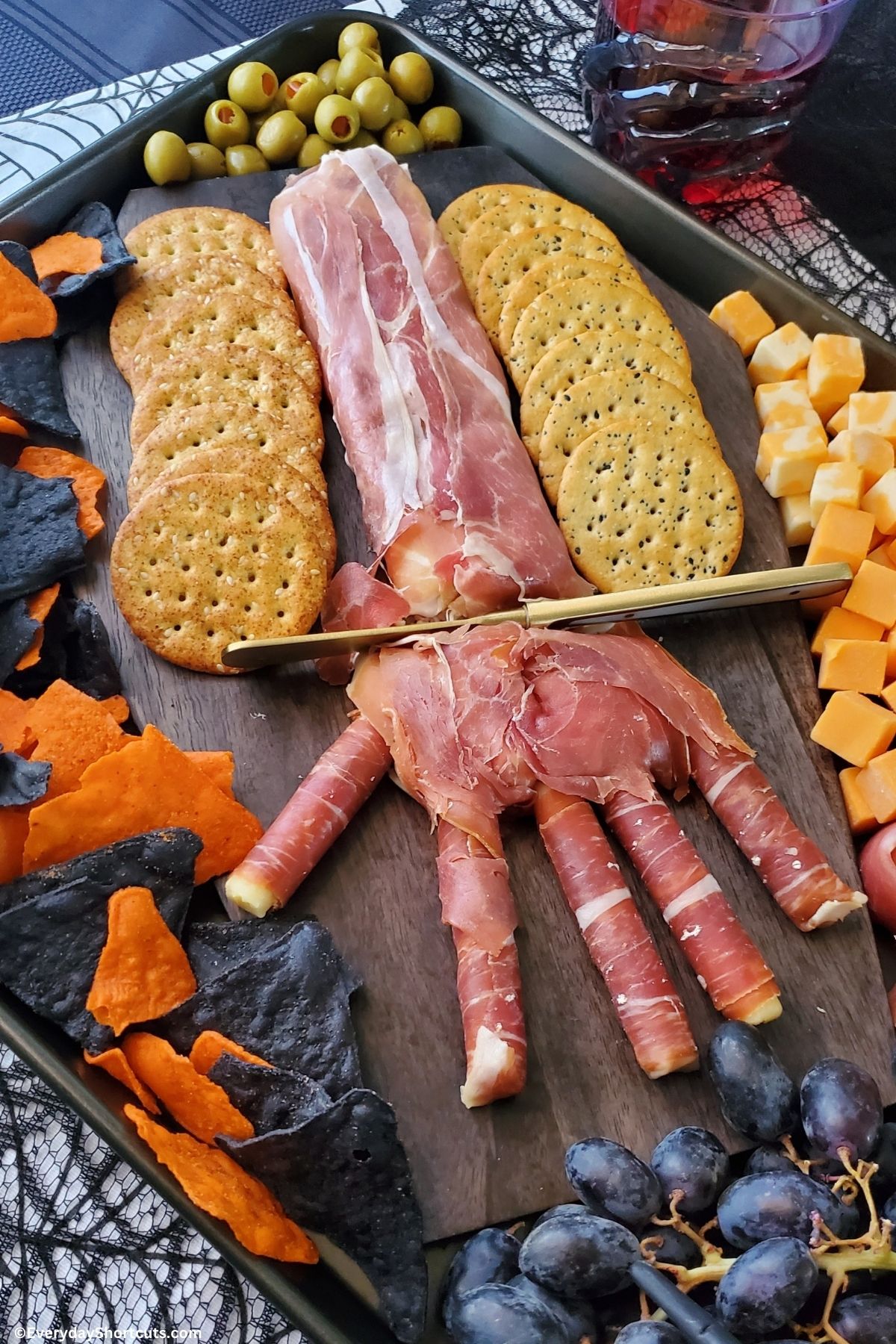 creepy hand appetizer on a charcuterie board