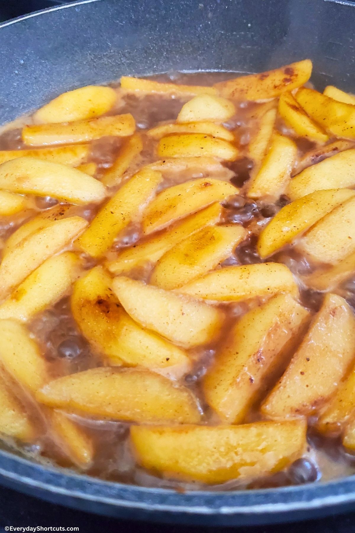 apples with brown sugar and apple cider in a pan