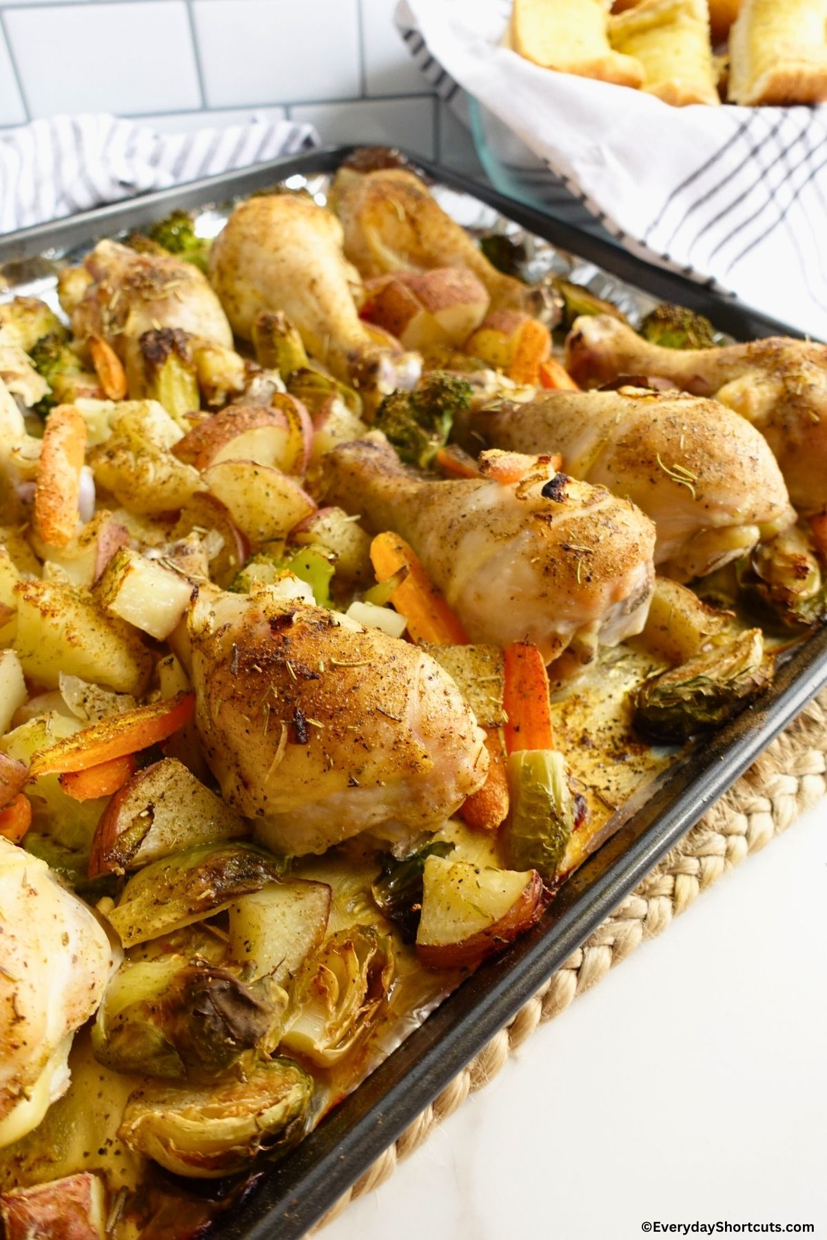 cooked chicken and veggies on a baking pan